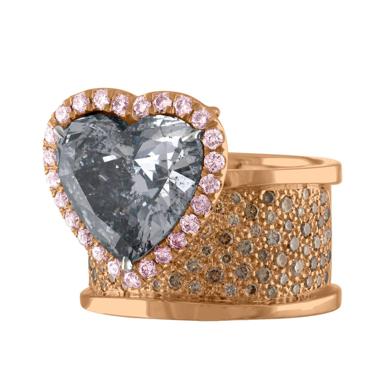 An Amazing looking Ring. 
The Center of this Breath Taking Rose Gold Ring is a Beautiful Heart Shape Diamond that has a very Unique Color to it - it is Certified as Fancy Gray by The GIA laboratory.
The Band is a Wide Band that is made out of 18K