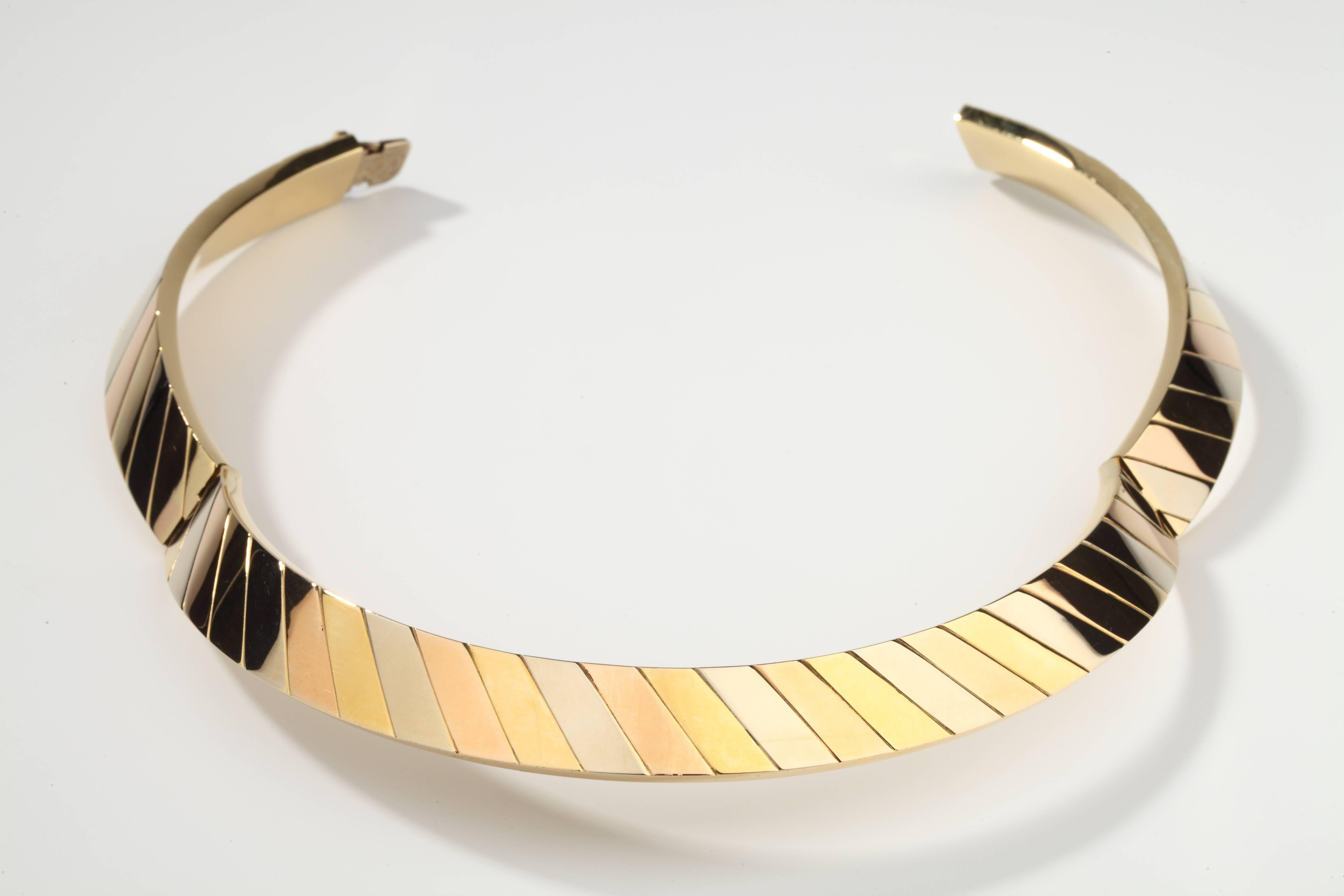 Opening stiff necklace made up of diagonal bands of three color gold (white, pink and yellow).
Signed FRED.