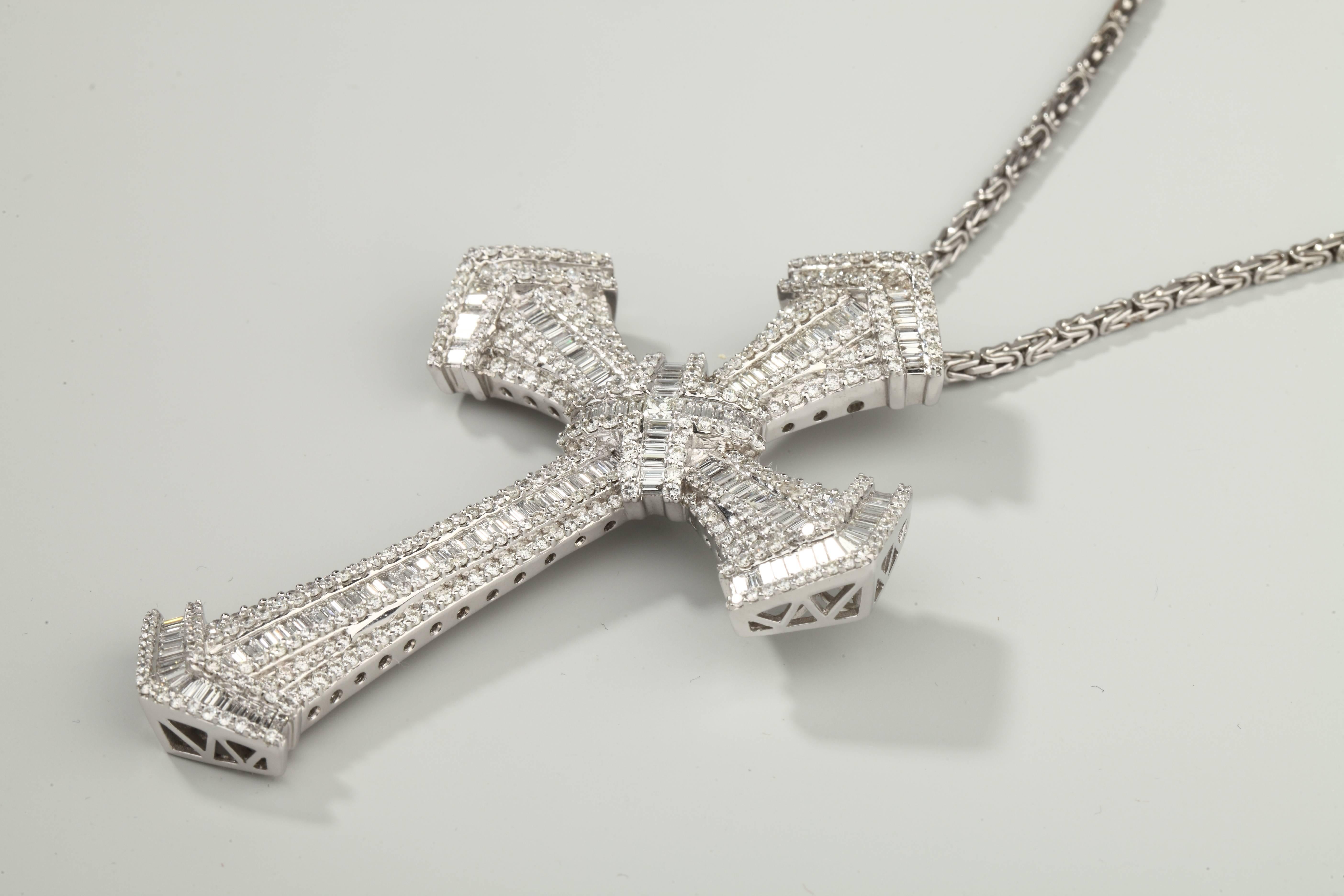 Large white gold cross entirely set with baguette cut and brillant cut diamonds.
Weight of the diamonds is around 15 carats and quality is F-G Vs.
Withe a white gold chain (  68 cm, 26,1 g)
