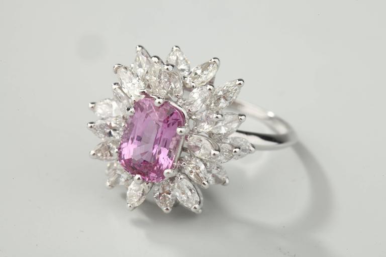 Marguerite ring in platinum set with marquise cut diamonds (G-VS) surrounding a cushion-cut pink sapphire.
Weight of the sapphire : 2,61 ct
Weight of diamonds : around 4,50 ct
Size : EU : 54,5  US : 7