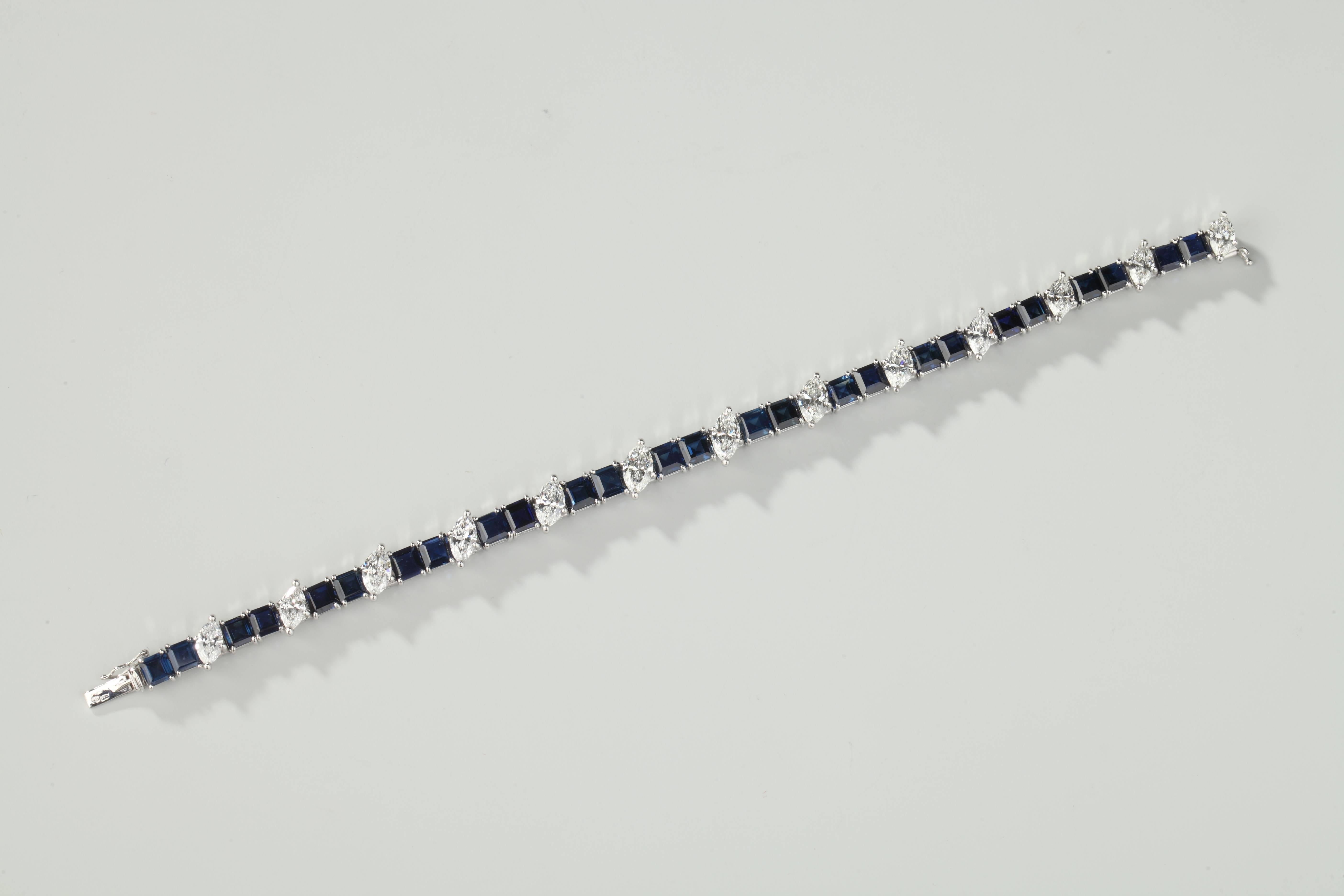 Platinum line bracelet set with 26 calibrated blue sapphires (around 40 ct) and 13 navette-cut diamonds (F-G Vs) around 6 ct. Clip in white gold (18ct).