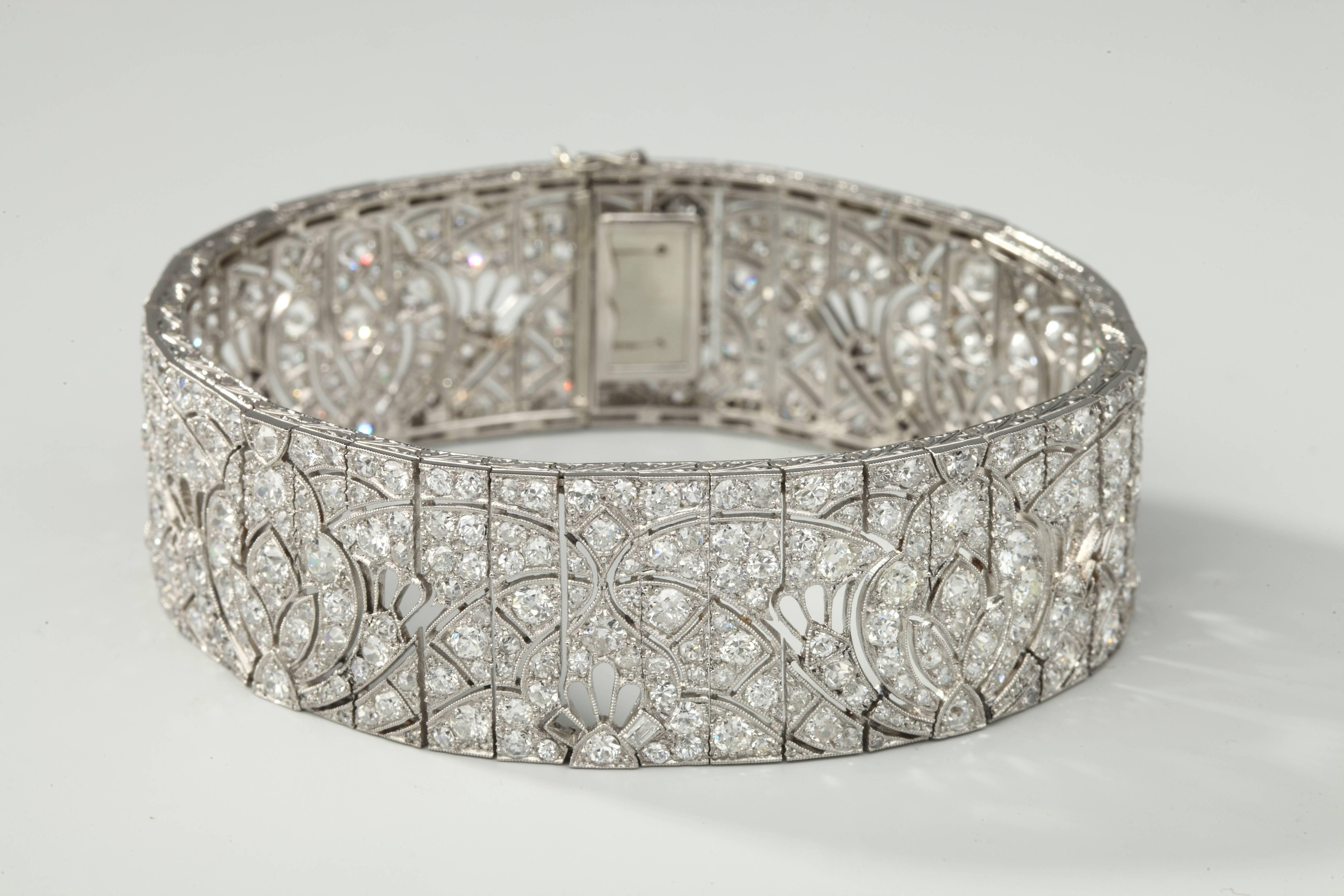 Fine ribbon bracelet in platinum, finely open work of leaf design and  millegrainset with old-cut diamonds.