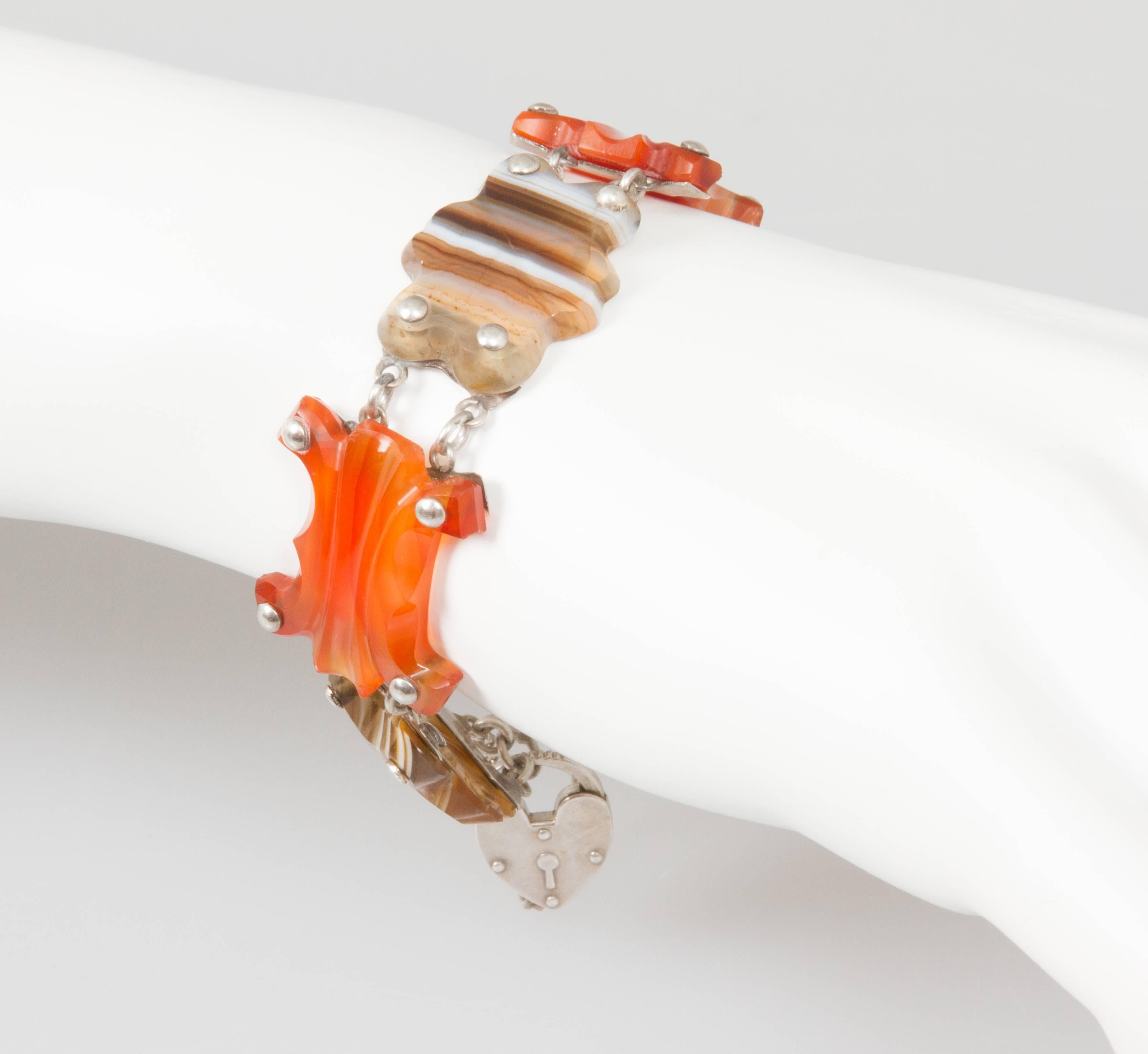 This is an interesting agate bracelet with simply carved agate elements and has that a sterling heart charm 