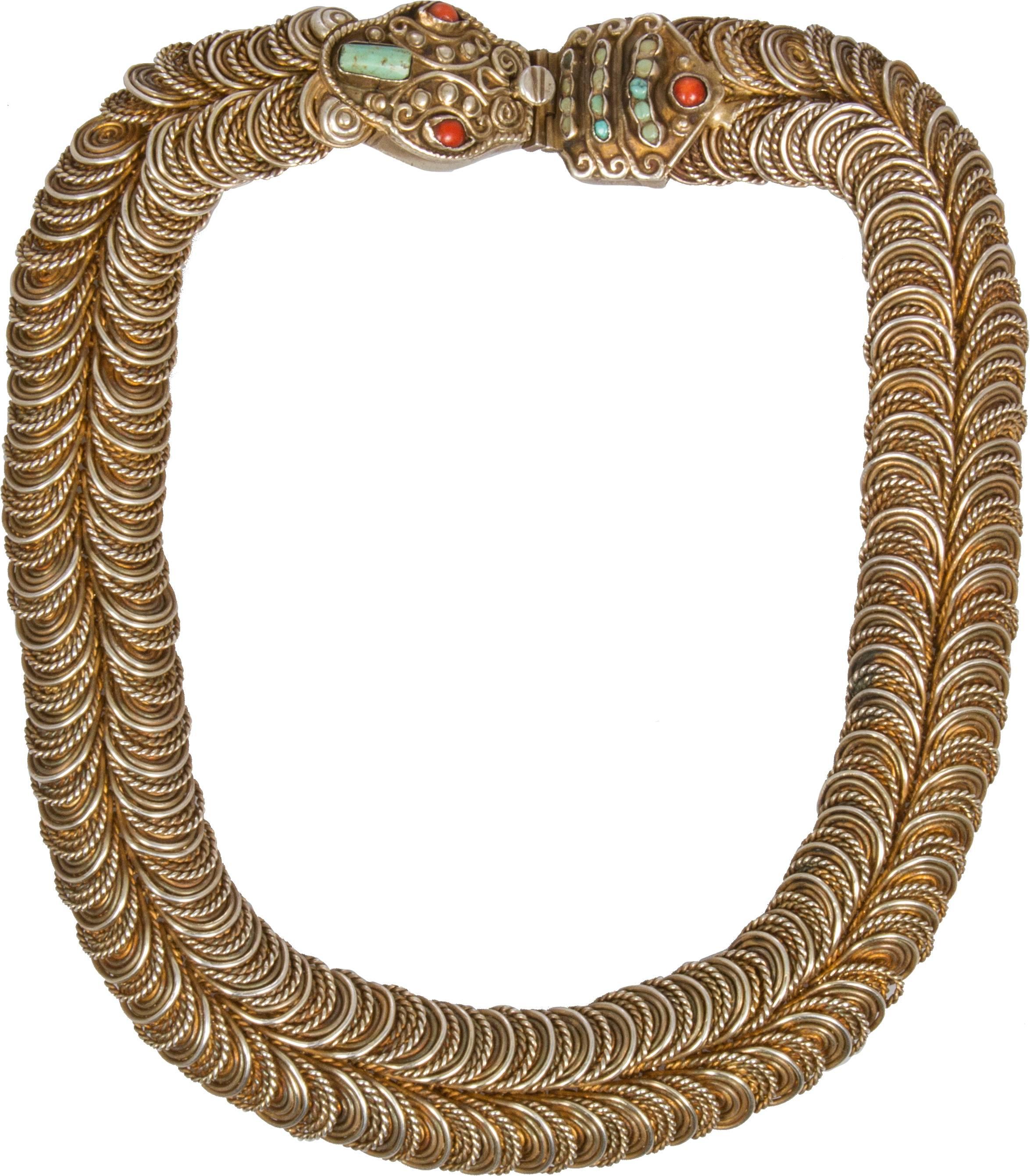 This is a wonderful necklace by Matilde Poulat.  The necklace is composed of gilt silver scales and turquoise