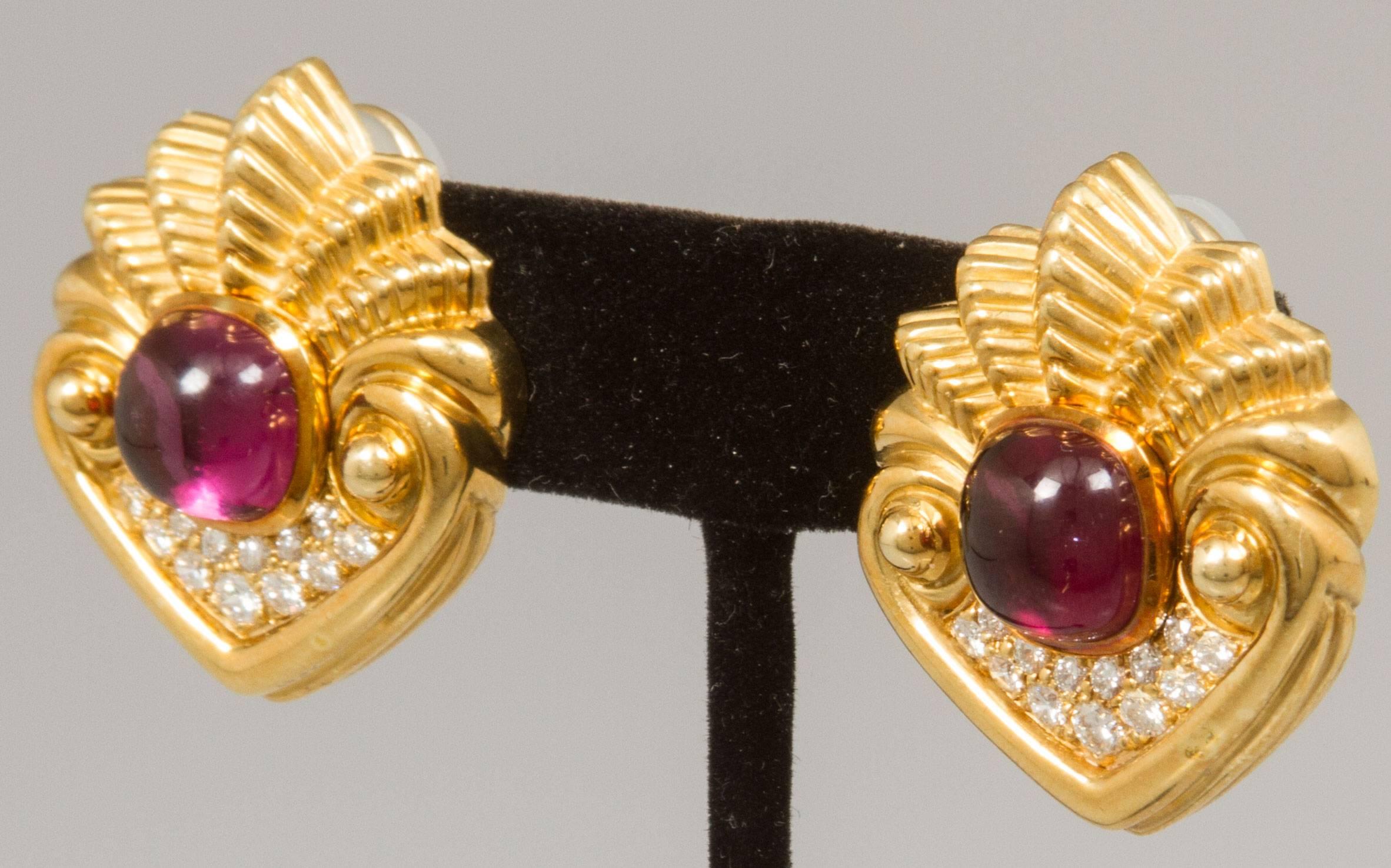 Cabochon cut amethysts and very high quality round diamonds adorn this pair of coquille shaped ear clips.  The gold casting is also very high quality