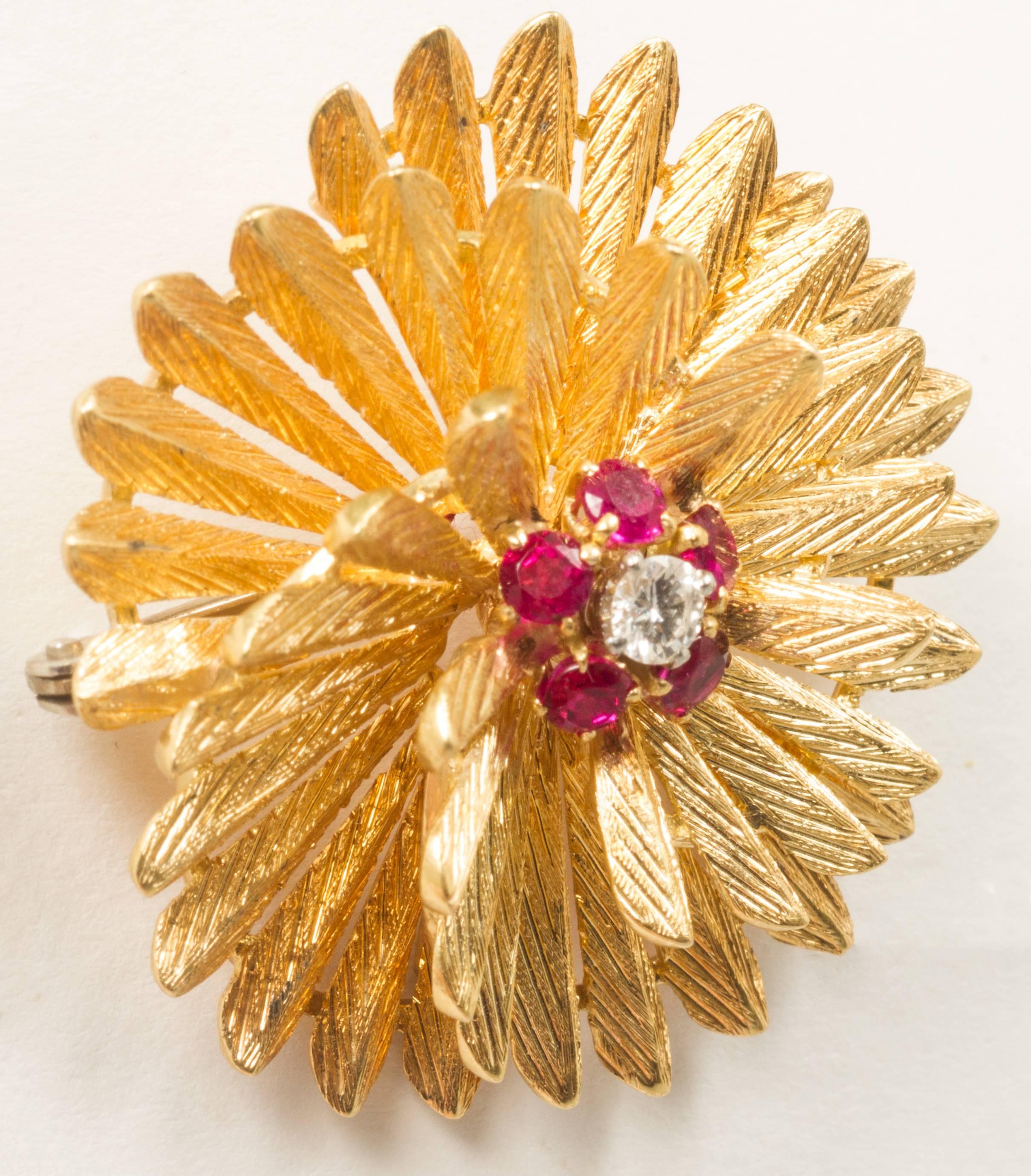 This is an interesting starburst having  textured feather like rays. A single diamond is surrounded by little rubies.