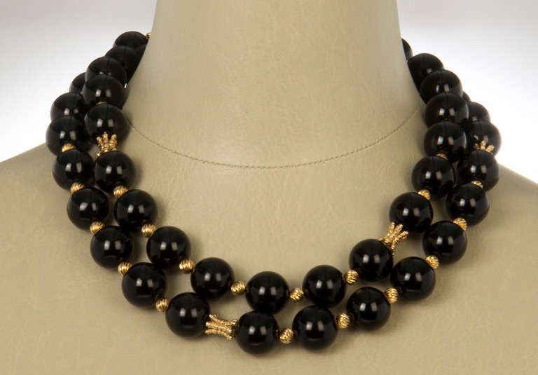 This necklace of has large onyx beads alternating with Mod 14K Gold sculptural elements and beads. The necklace can be worn twice around the neck if one uses a pearl extender.  The size of the bead is around a 10mm