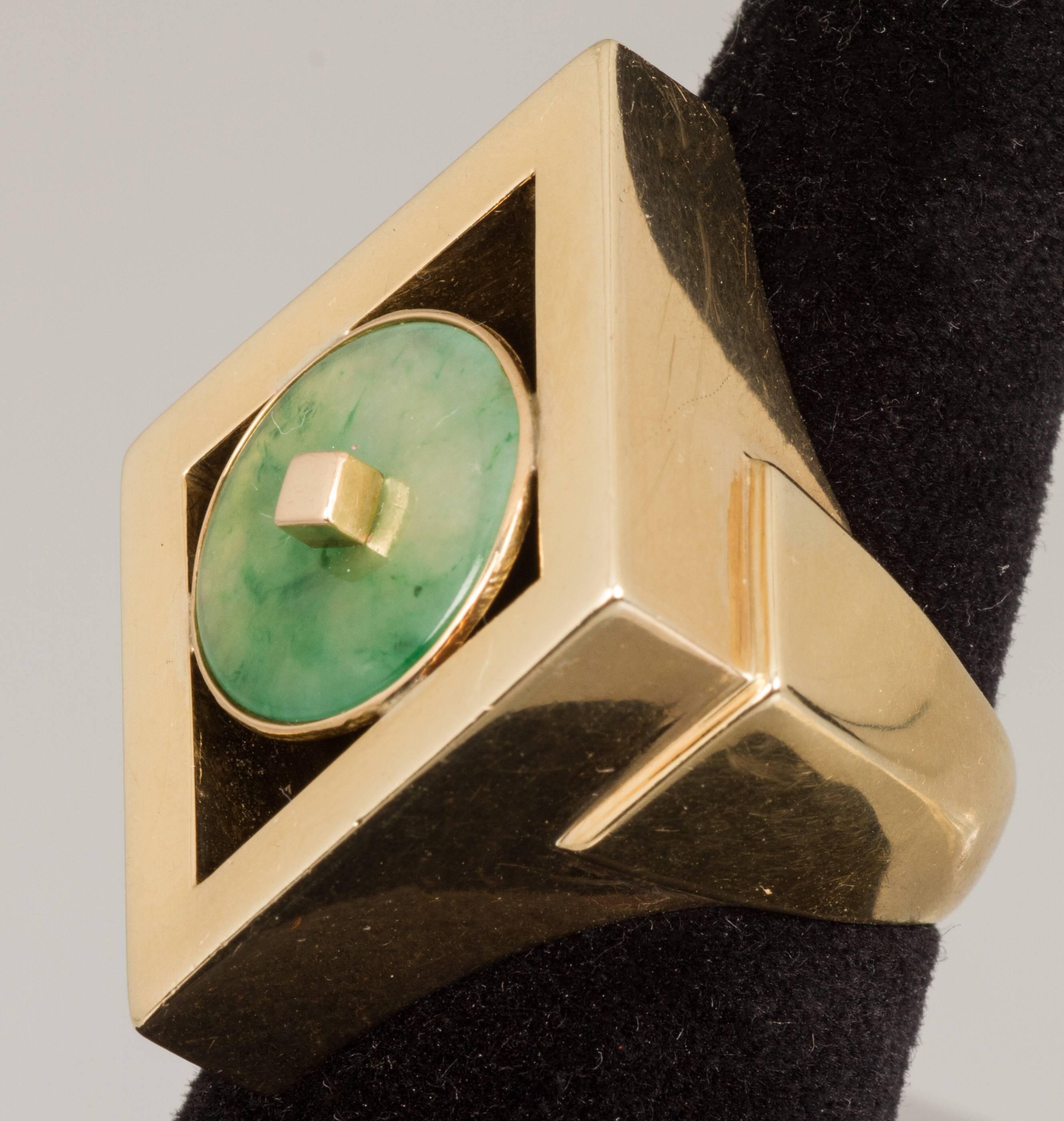 This is a bold modernist ring in a diamond form. The jade is bezel set.

The ring is a size 9.