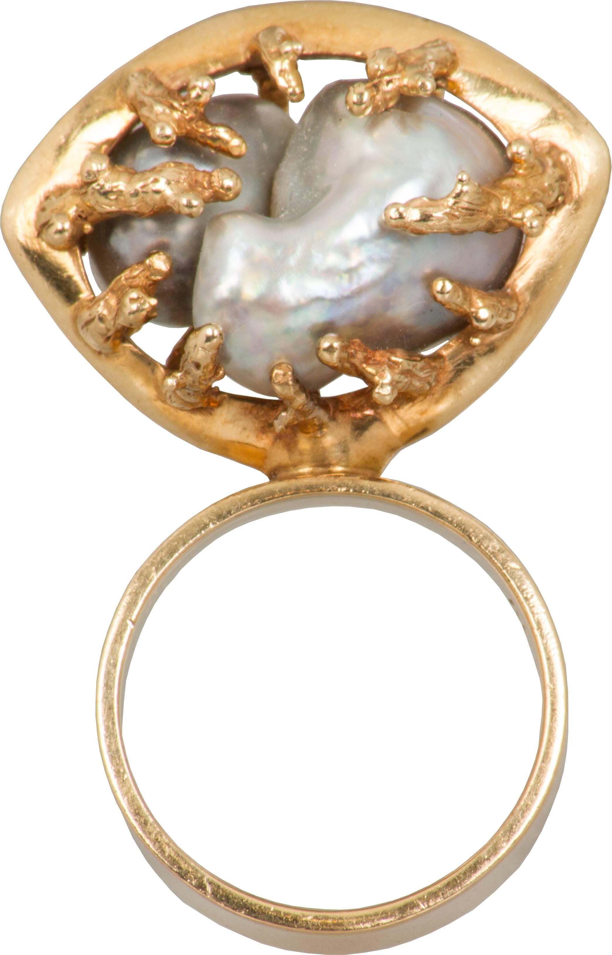 The gold surround is coral like in this modernist ring.

The ring is a size 7.5.