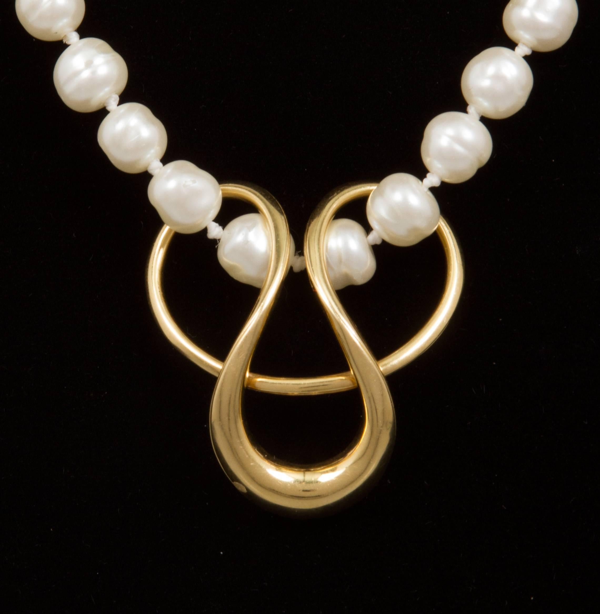 This  modern sculptural pendant would work on a gold chain, pearls or velvet cord.