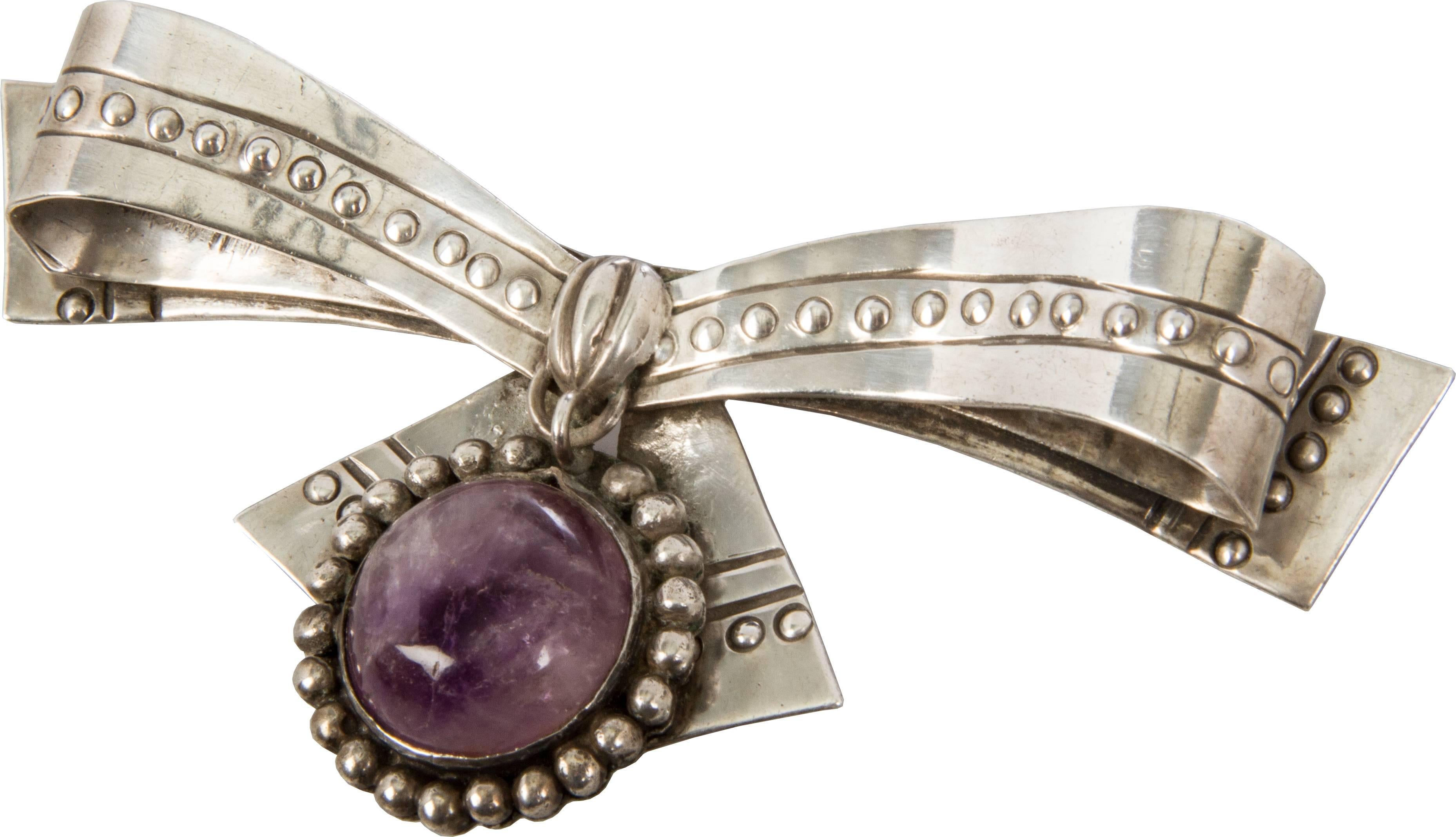 This is a nice example of Spratling's early work featuring raised beading and an amethyst cabochon.