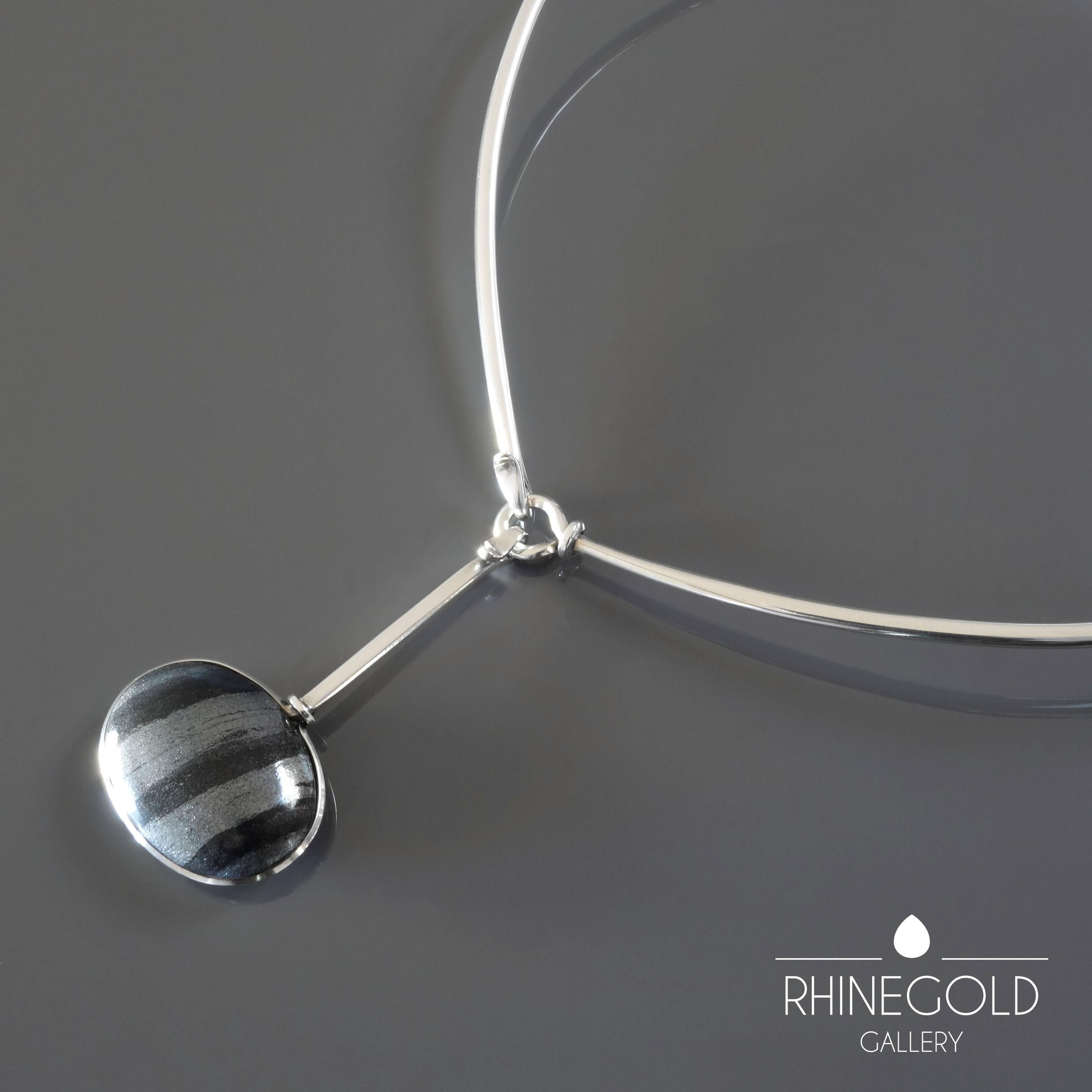 Torun Bülow Hübe for Georg Jensen: Modernist Silver Neck Ring #174 with Hematite Silver Drop Pendant #129
Sterling silver, hematite
Neck ring: L 45 cm (approx. 17 ¾”)
Pendant: L 6.2 cm, W 3.1 cm (approx. 2 7/16” to 1 ¼”)
Weight approx. 45.5
