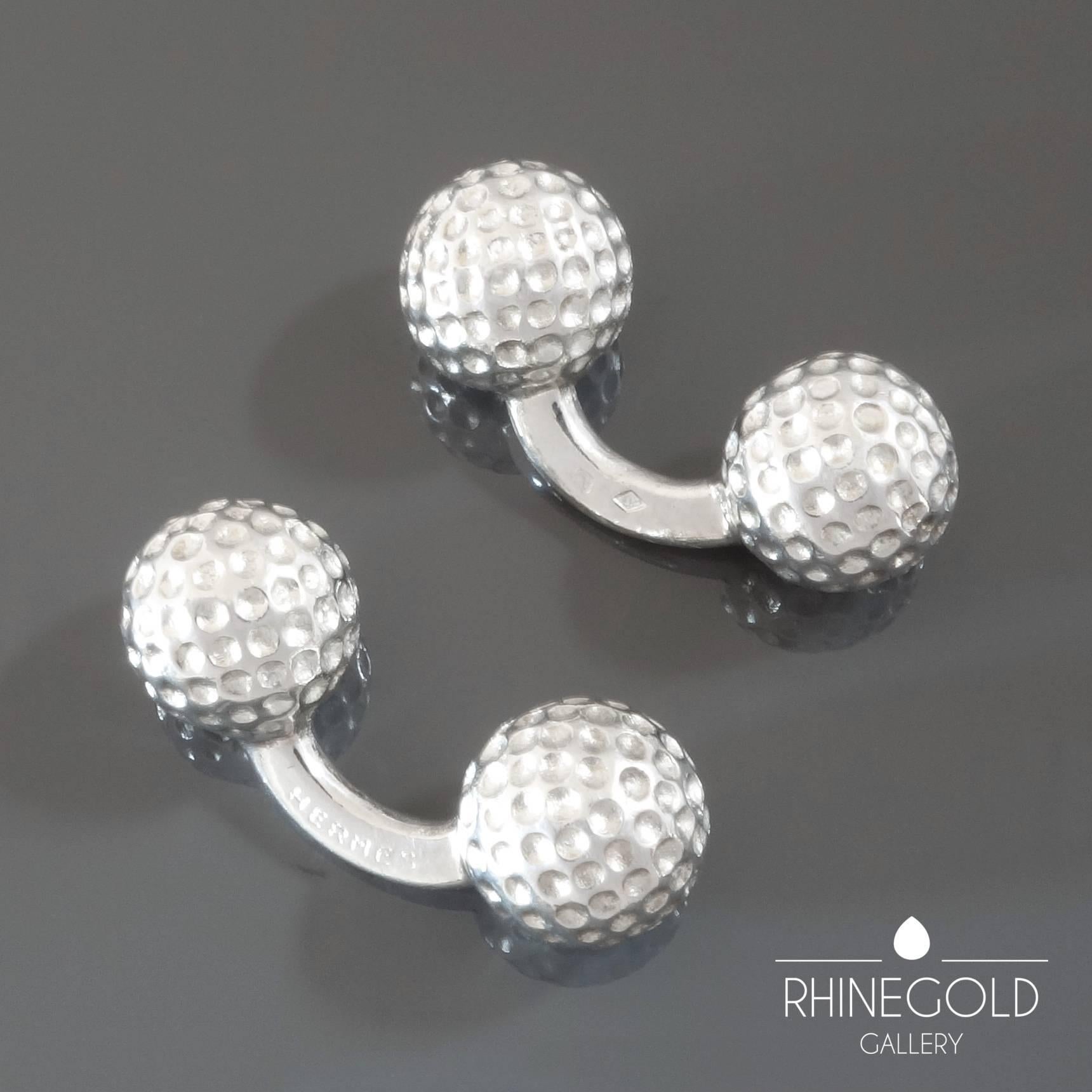 Hermès:  A Pair of Silver Golfball Cufflinks
Weight approx. 22.2 grams
Diameter of golf balls 1.0 cm (approx. 3/8”)
Marks: ‘HERMÈS’, French crab mark for silver, maker’s mark
France, 1970s - 1984

Solid, easy to adjust and to wear. Classic.
