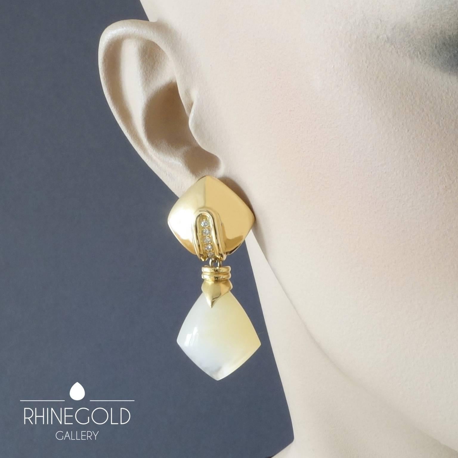 Detachable pendants carved from the finest creamy white Macassar mother-of-pearl, set in 18k gold, correlate in shape with the domed square ear studs, each set with a row of five brilliant cut diamonds (vvs). The earrings can also be worn with other