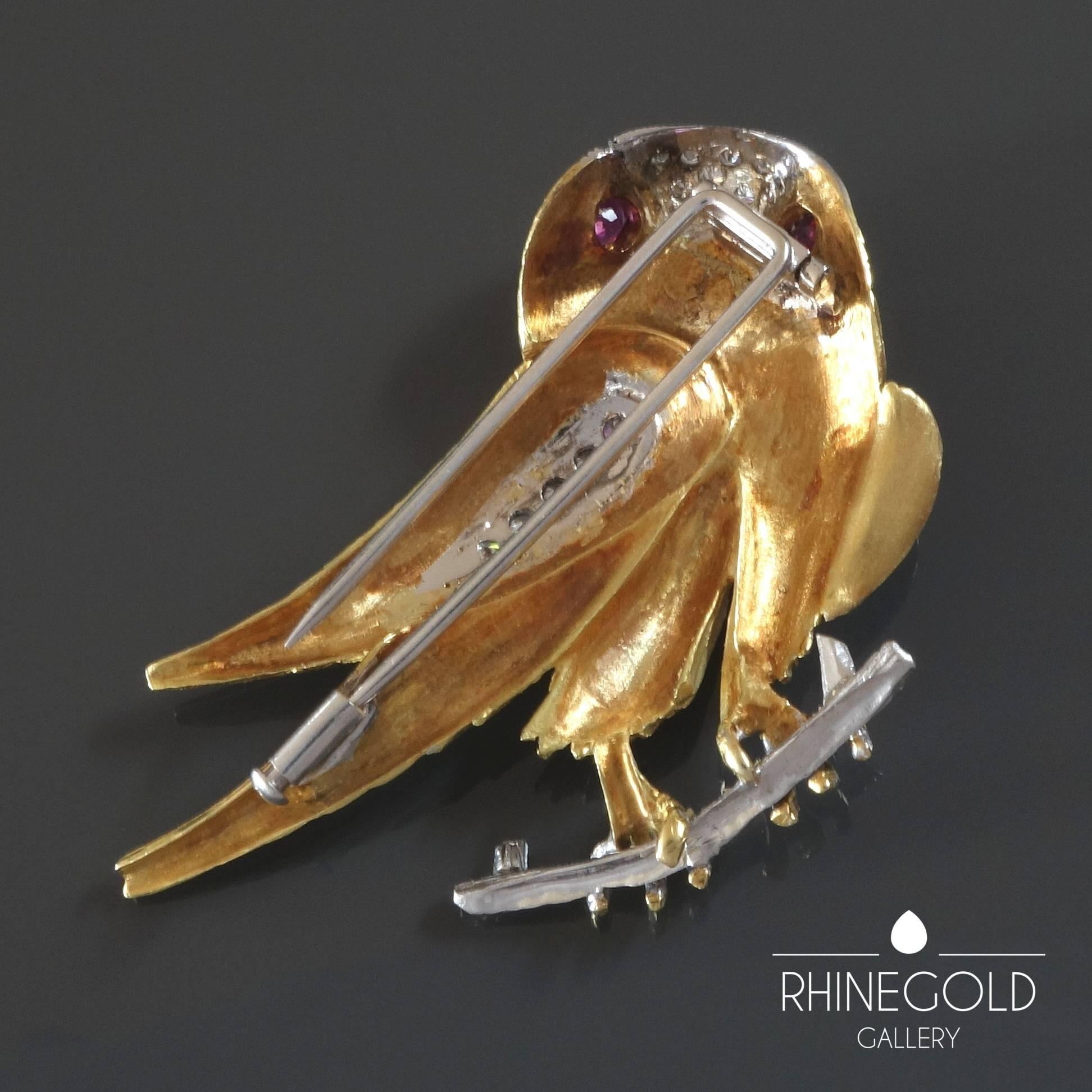 1970s Diamond Ruby Gold Falcon Bird Brooch
18k yellow and white gold, 2 facetted rubies (approx. 0.5 ct. in total), 13 brilliant cut diamonds (top wesselton, vvs, approx. 0.5ct. in total)
Size 4.8 cm by 5.6 cm (approx. 1 7/8” by 2 3/16”)
Weight