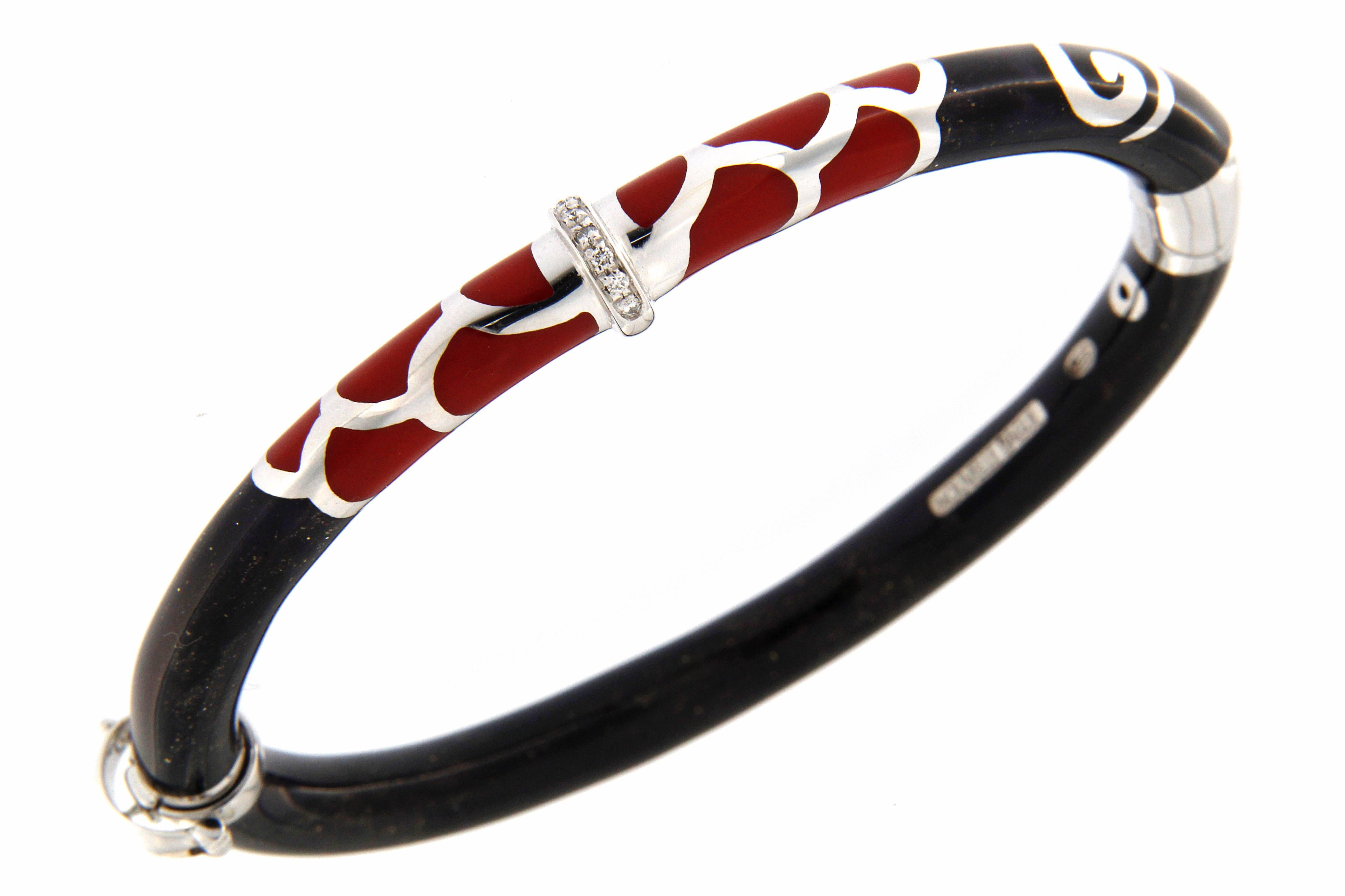 beautiful bangle bracelet made in gold (gr. 12.92) and silver (gr. 8,01), fire enamel black and red color and tiny full cut diamonds total weight ct. 0.06