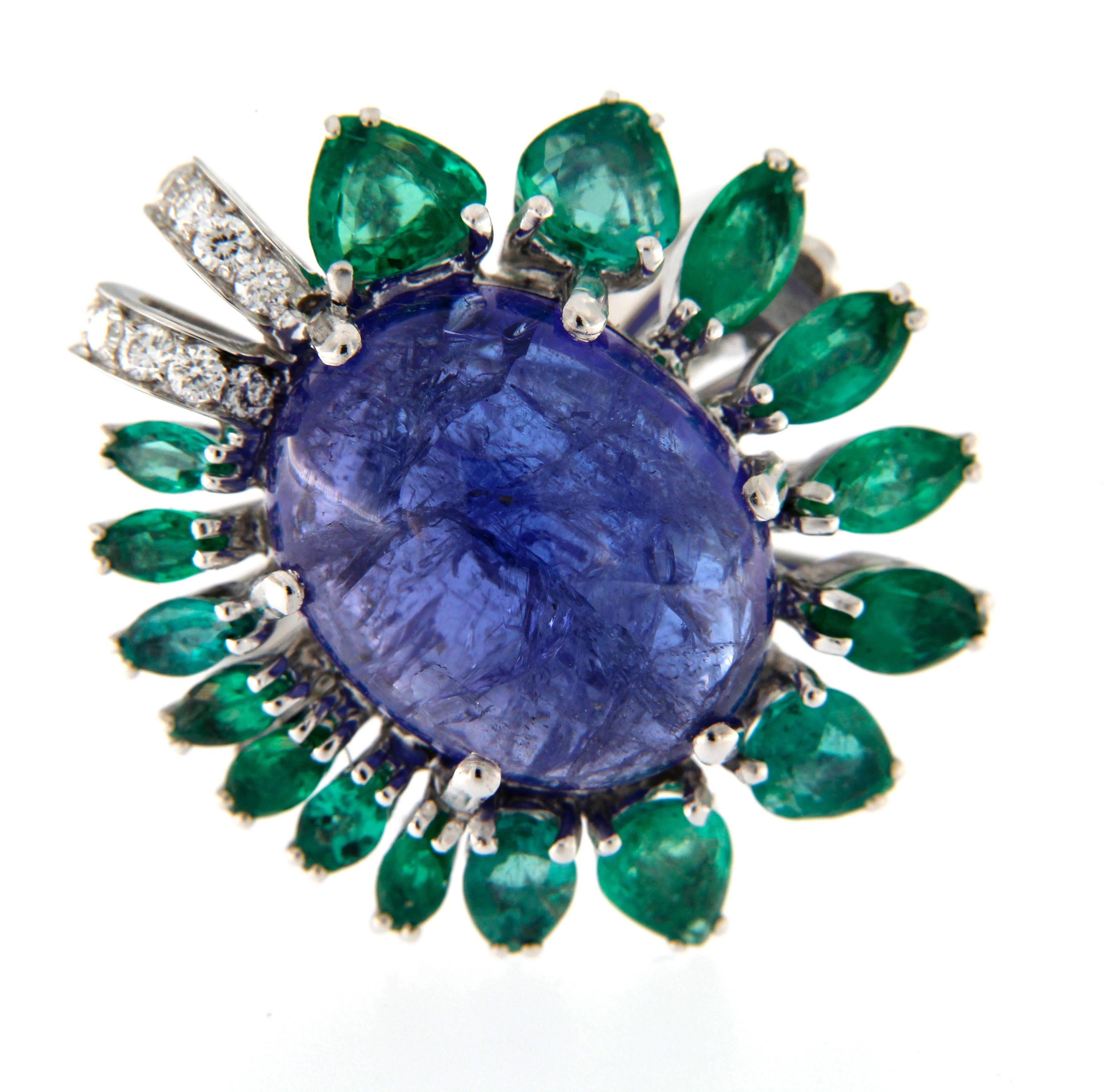 Own production, huge cabochon cut Tanzanite ct. 12.73 , surrounded by Colombian Emeralds ct. 3.07 and full round cut diamonds ct. 0.17
the ring can be sized before shipping