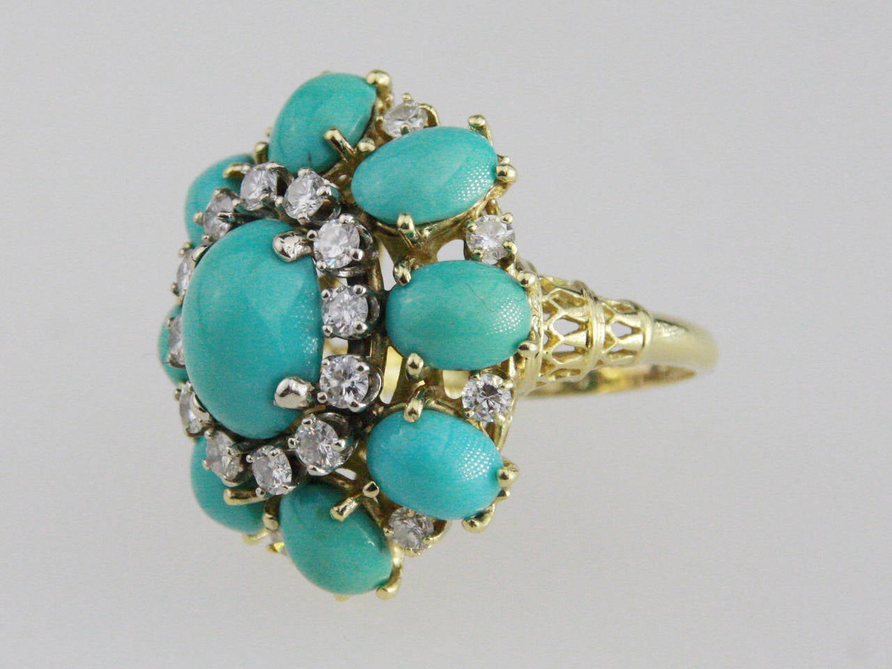 The ring is set with 9 oval turquoise cabochons, and 20 round diamonds. 
Size 5. Can be sized at no charge.