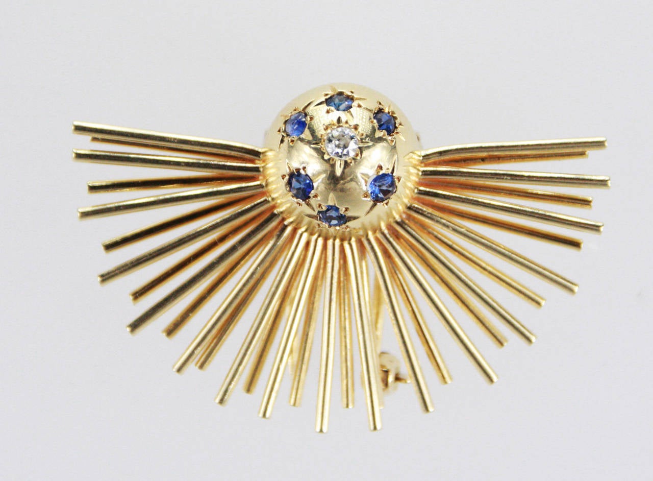 Sputnik style brooch set with an Old European cut diamond weighing approximately 0.10 carats and 6 sapphires weighing approximately 0.45 carats. Signed Tiffany & Co.