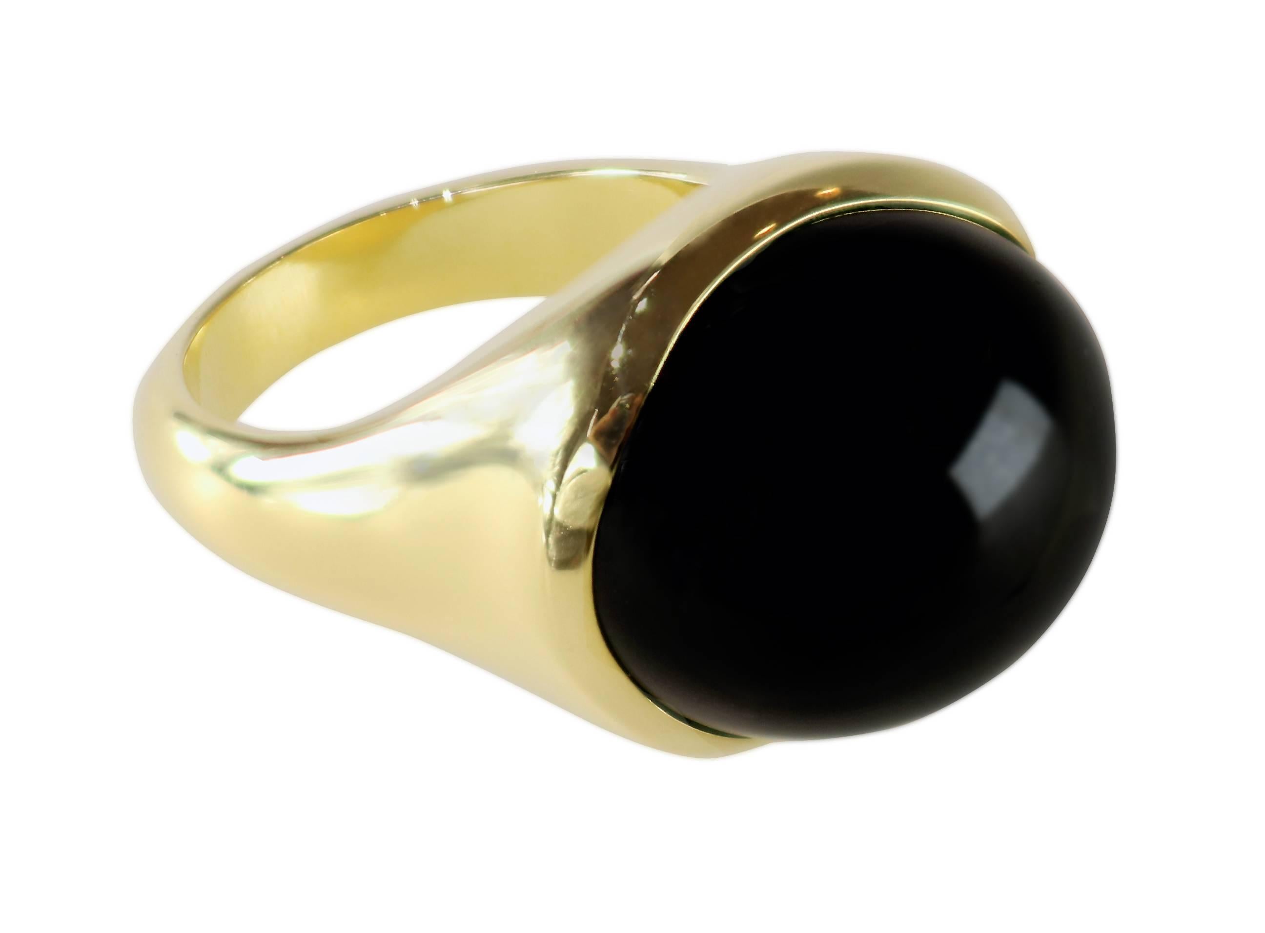 An 18K yellow gold ring set with cabochon black jade measuring 18mm x 20mm. It is 16mm high. The ring is size 7. Stamped Tiffany & Co., Elsa Peretti Hong Kong. With Tiffany pouch.