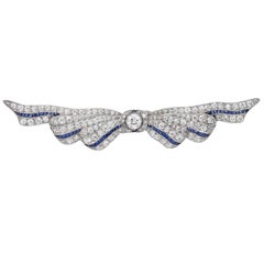 3 Carat Diamond and Sapphire Ribbon Platinum Brooch. Circa 1930