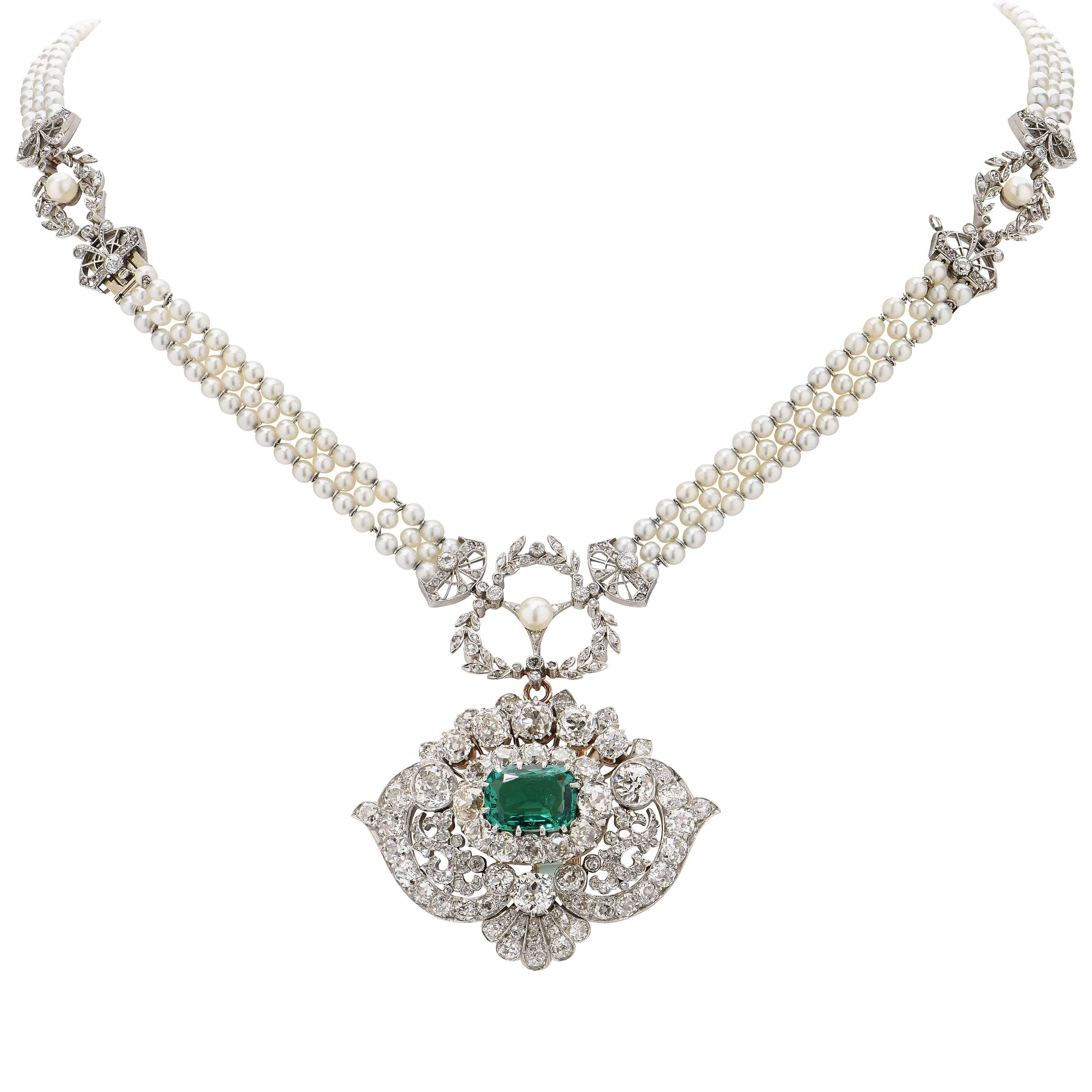 Signed Tiffany & Co. This Scroll Motif  Emerald & Diamond Pendant contains a rare AGL Graded 2.85 Carat CLASSIC COLOMBIA Emerald surrounded by approximately 11.8 carats of old mine cut diamonds set in platinum. The pendant is estimated as being