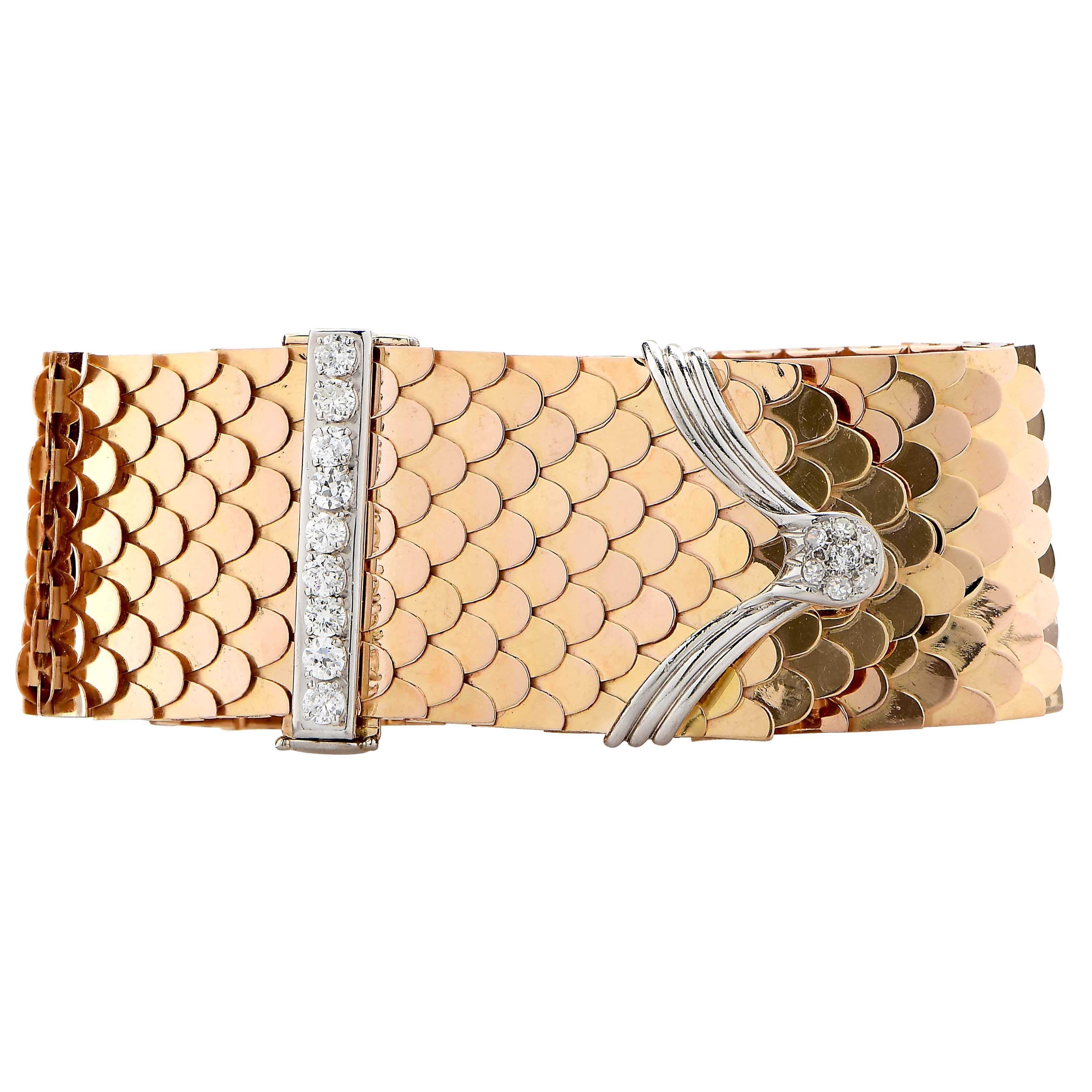 1940's Retro Diamond Buckle Bracelet featuring an intricate and flexible scale design which flows like silk and 16 diamonds with an estimated total weight of 1.5 carats.
Metal Type: 18 Karat Yellow Gold
Metal Weight: 136.1 Grams
Bracelet Length: 9.5