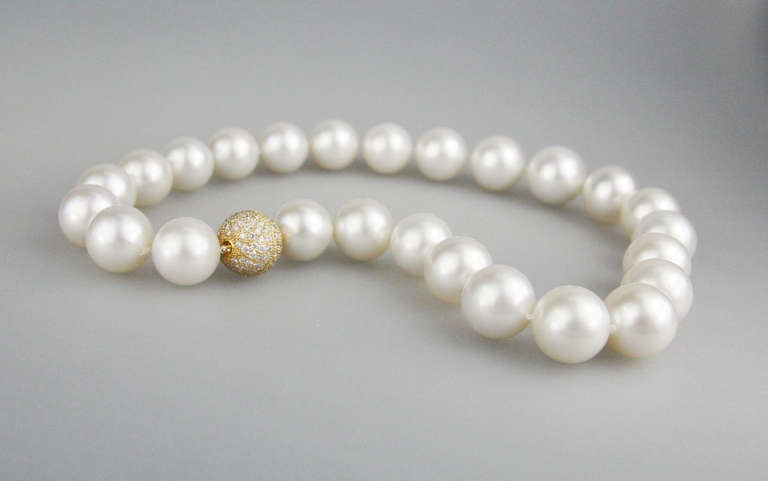 South sea cultured pearl necklace with 25 round pearls ranging in size from 
18 millimeters to 15 millimeters. The necklace is finished with a 18K yellow gold and diamond clasp.