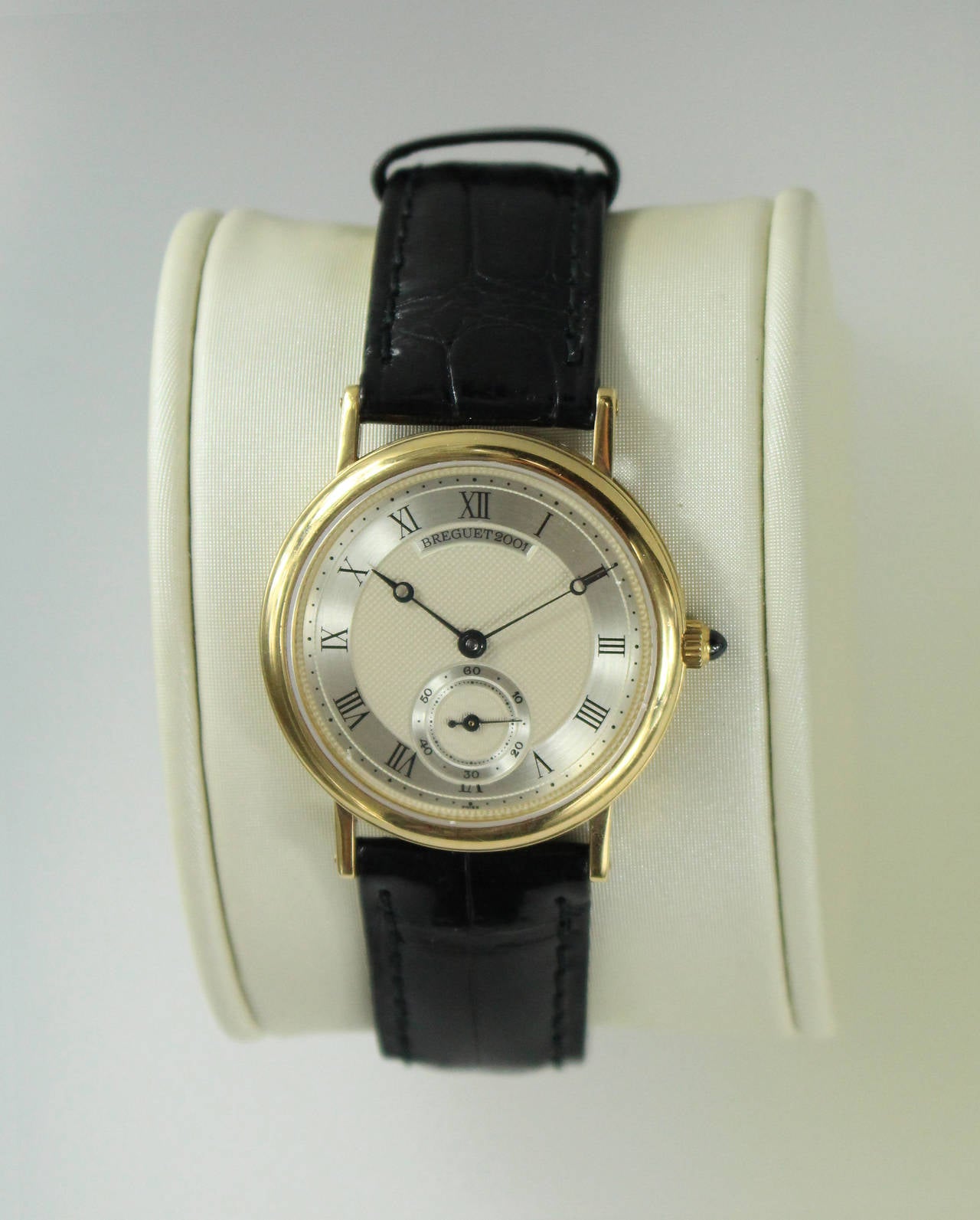 Breguet classique manual wind watch on a black strap with a gold tang buckle. 
Second hand at  6 o'clock.
Diameter 33mm.