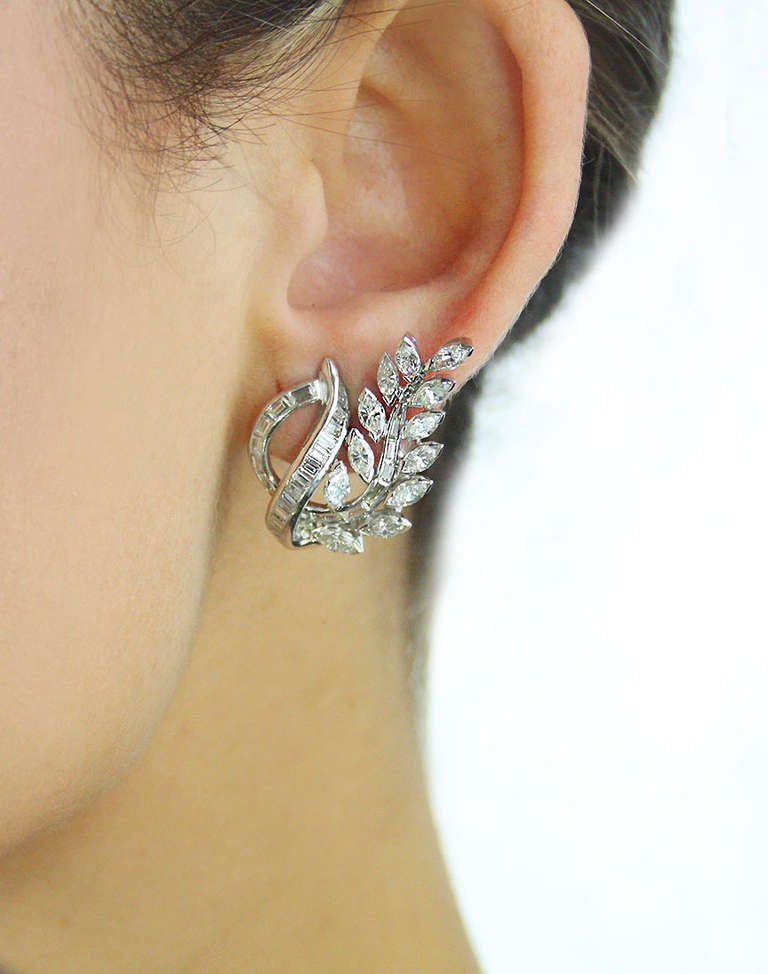 These beautiful floral motif platinum ear clips are set with marquise and baguette shaped diamonds weighing approximately 5 carats.
There are 60 baguette cut diamonds and 24 marquise cut diamonds. The diamonds average G/H color VS1/ VS2