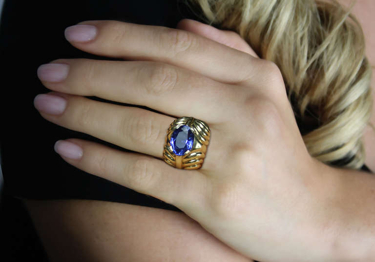 1940's Boucheron Paris sapphire ring features a oval sapphire weighing 5.15 carats. The sapphire is graded by AGL as origin- Burma, not heated. It is set in a highly stylized fluted gold retro ring. Signed Boucheron Paris, with French hallmarks.