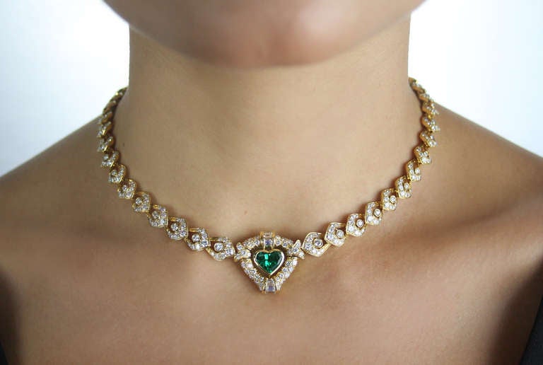 Italian necklace set with a heart shaped emerald weighing approximately 1.50 carats, and a oval shaped diamond weighing approximately 0.50 carats. 
It is further set with 432 diamonds weighing approximately 8.80 carats. 
Length is 15 1/2