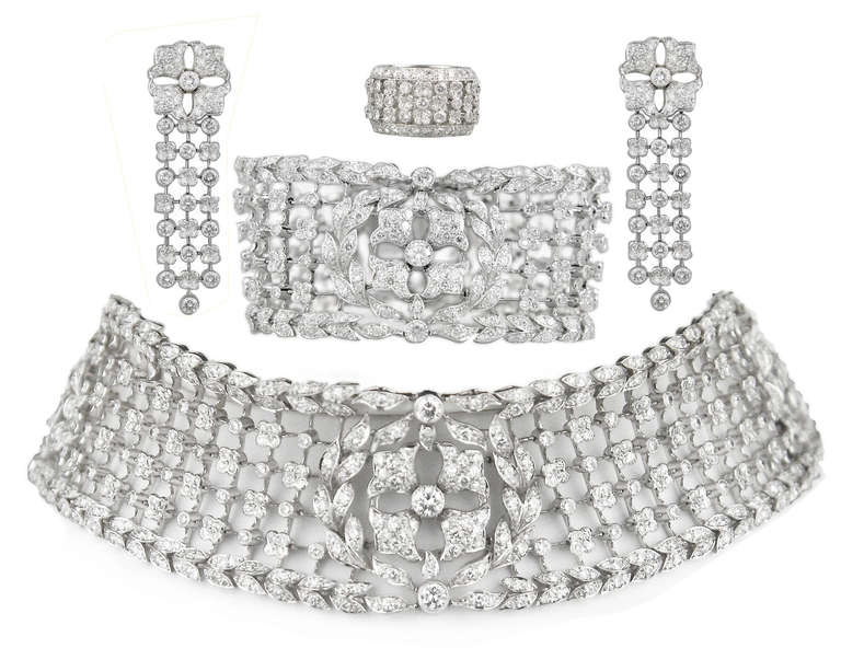 Rare 1980s Cartier Parure, made in France and  set with round diamonds. Diamonds are E/F in color, and VVS to VS in clarity. 
The necklace is a very flexible collar with an internal circumference of 13.50