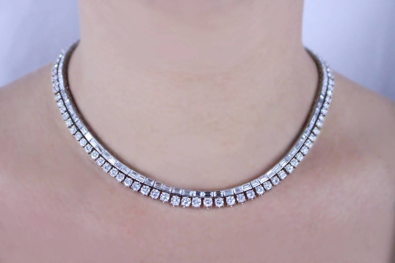 Platinum Diamond necklace set with approximately 30 carats of diamonds (16 carats of round diamonds, and 14 carats of baguette diamonds). The quality of the diamonds are F/G in color and VS in clarity. The length of the necklace is 16 inches.

Metal