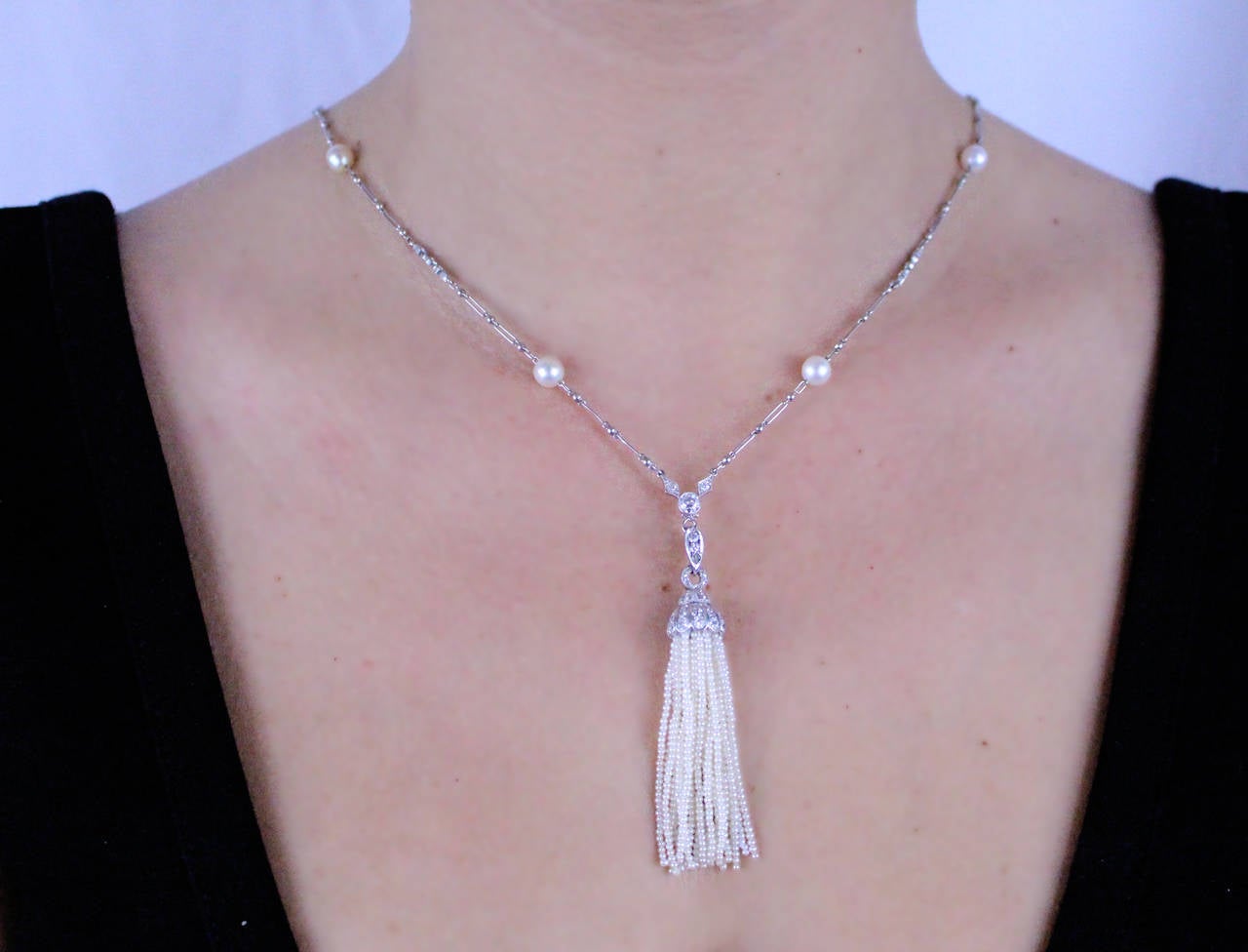Platinum necklace with 6 diamond sections weighing approximately 1 carat, and 12 cultured pearls measuring 5 1/2mm. Removable natural seed pearl tassel set with old mine diamonds. 
Necklace is 30