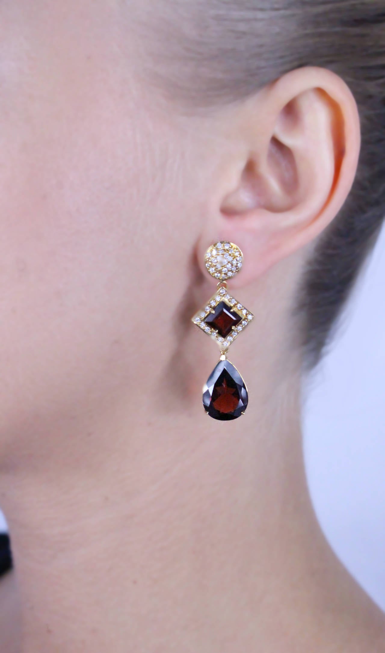 Gorgeous Drop Earrings set with 2 square and 2 pear shape almandine garnets weighing 20.72 carats and round brilliant cut diamonds weighing 0.70 carats.

Earrings length: 1.75 Inches
Metal Type: 18 Karat Yellow Gold
Metal Weight: 12.8 Grams