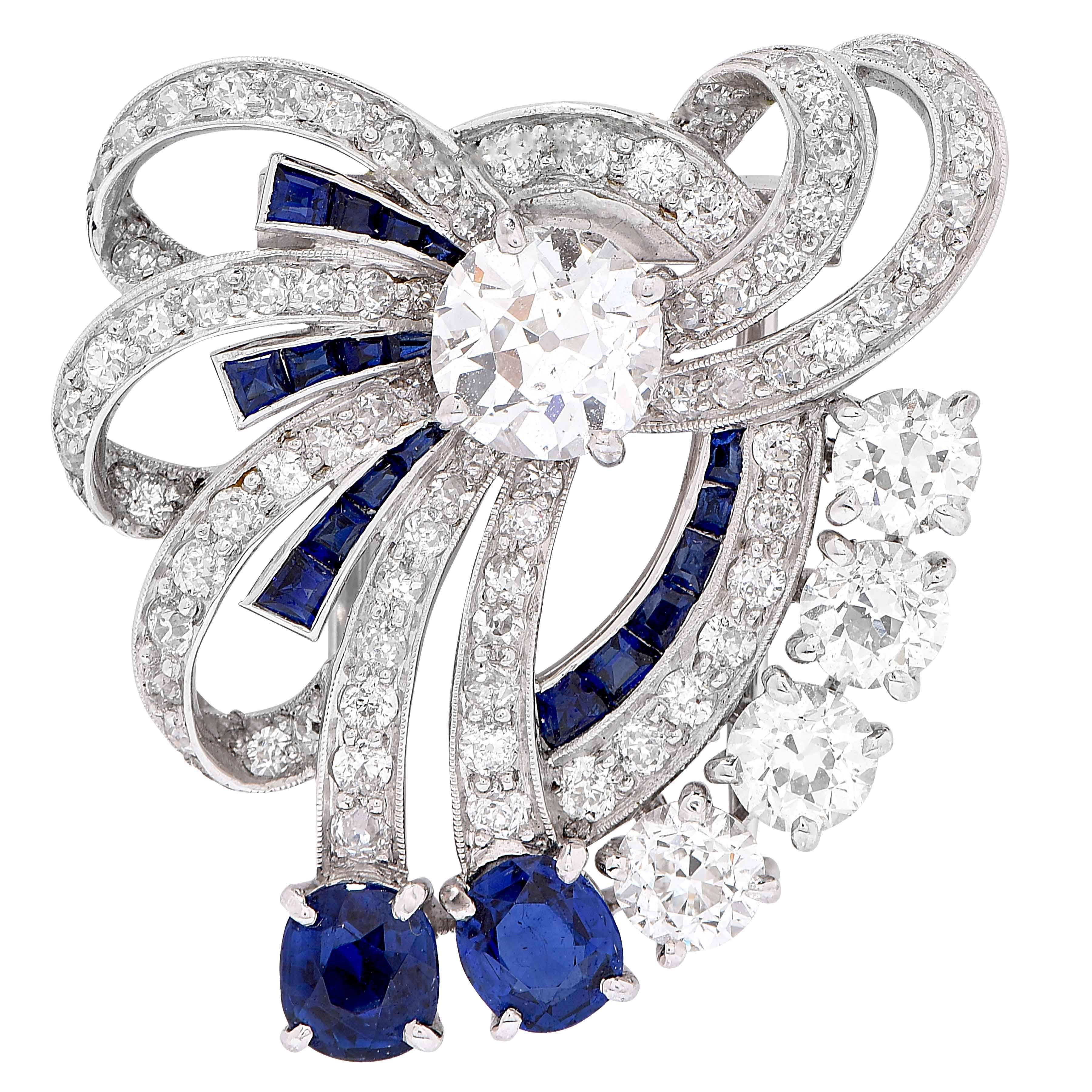 Gorgeous Yard Sapphire and Diamond Platinum Bow Clip. The stylized bow is centered on one old-mine cut diamond weighing approximately 1.25 carats, further set with 75 Old European and single cut diamonds weighing an additional 2.35 carats. There are