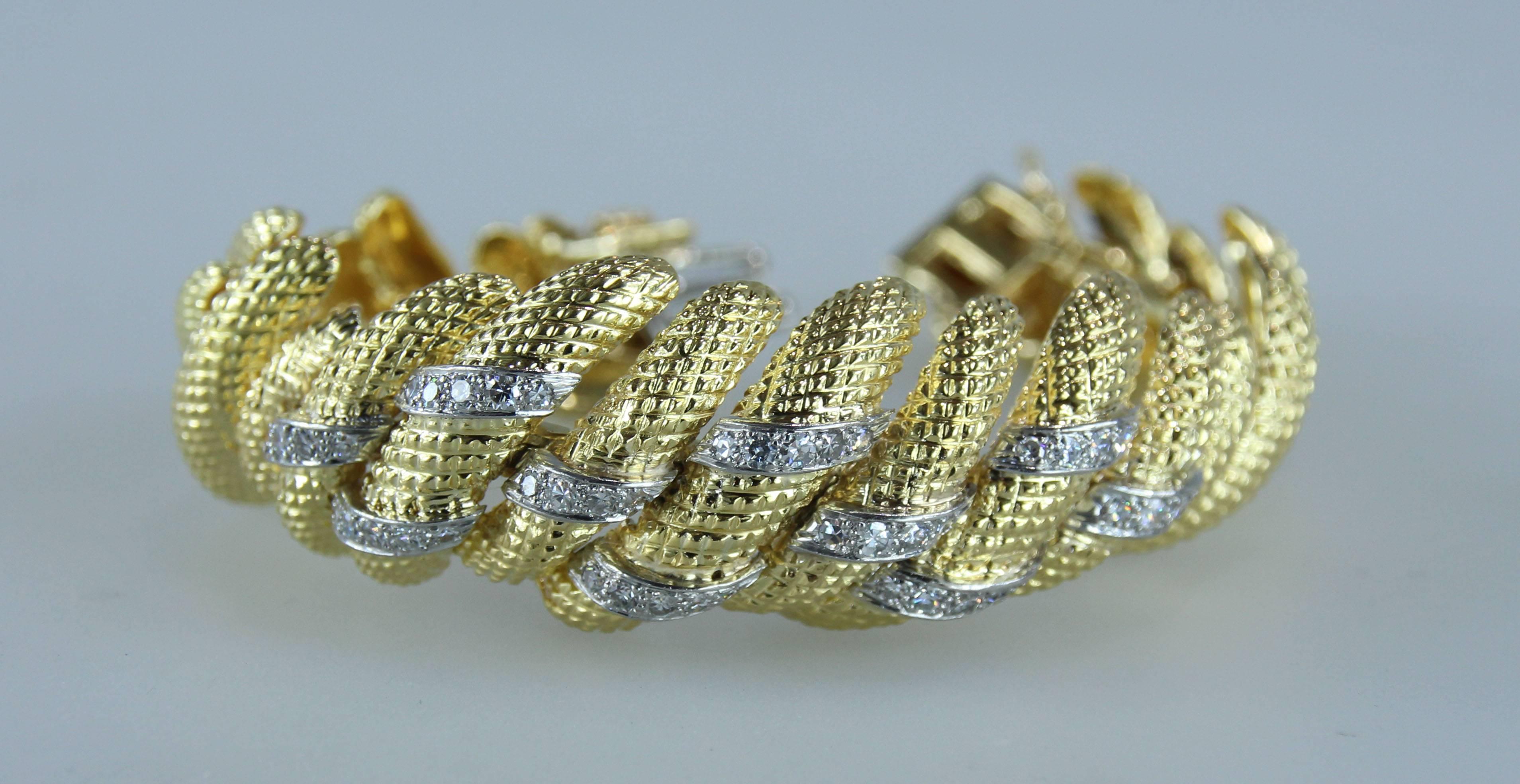 David Webb bracelet from the 1970's. Highly articulated bracelet with 46 single and full cut diamonds weighing approximately 1.40 carats. Signed Webb 18K
Length 7 inches. Widest point 7/8 of an inch. 