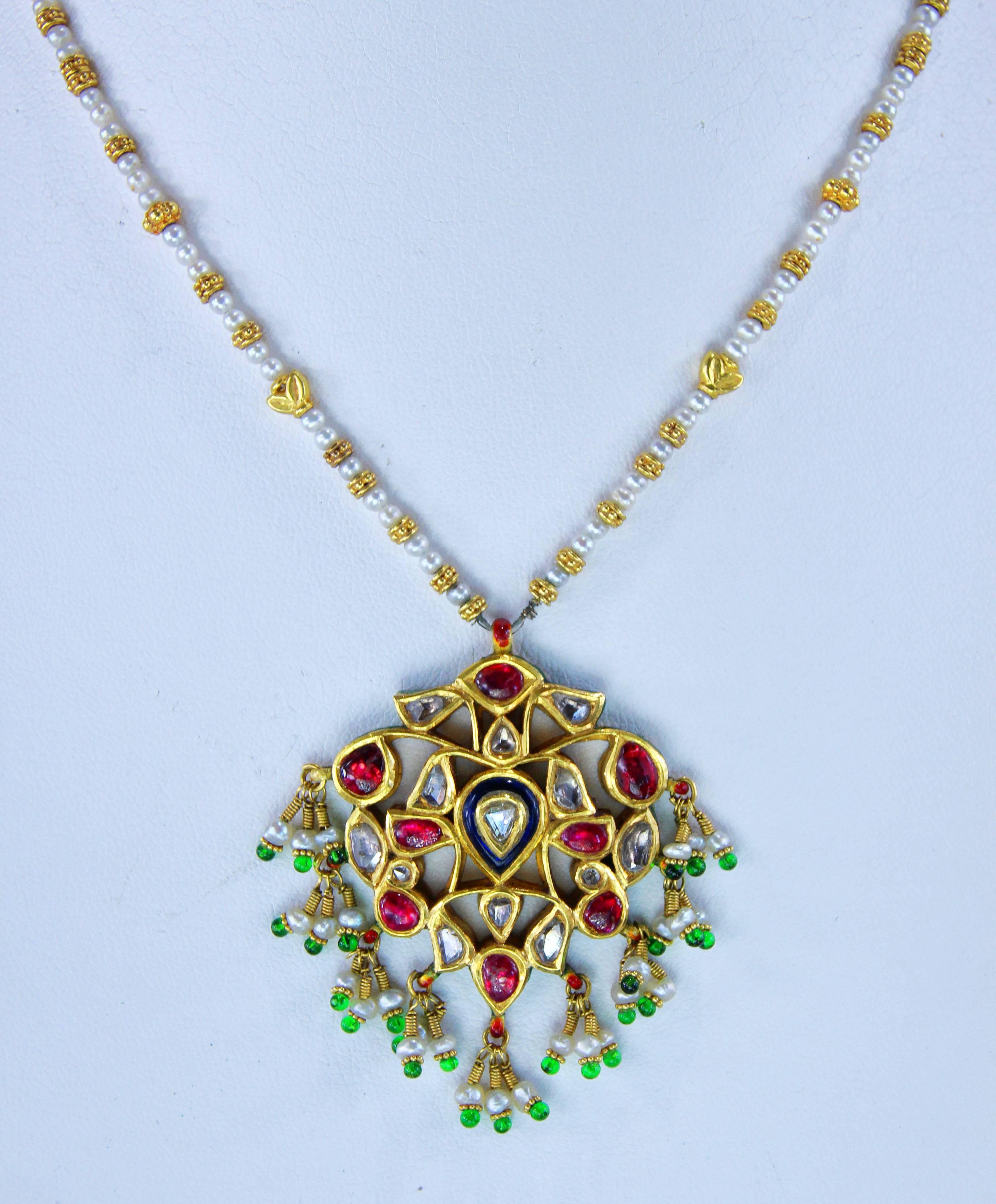 Necklace made in India, set with rose cut diamonds, seed pearls, semi-precious stones and enamel. Necklace is reversible, and is 15 inches long.