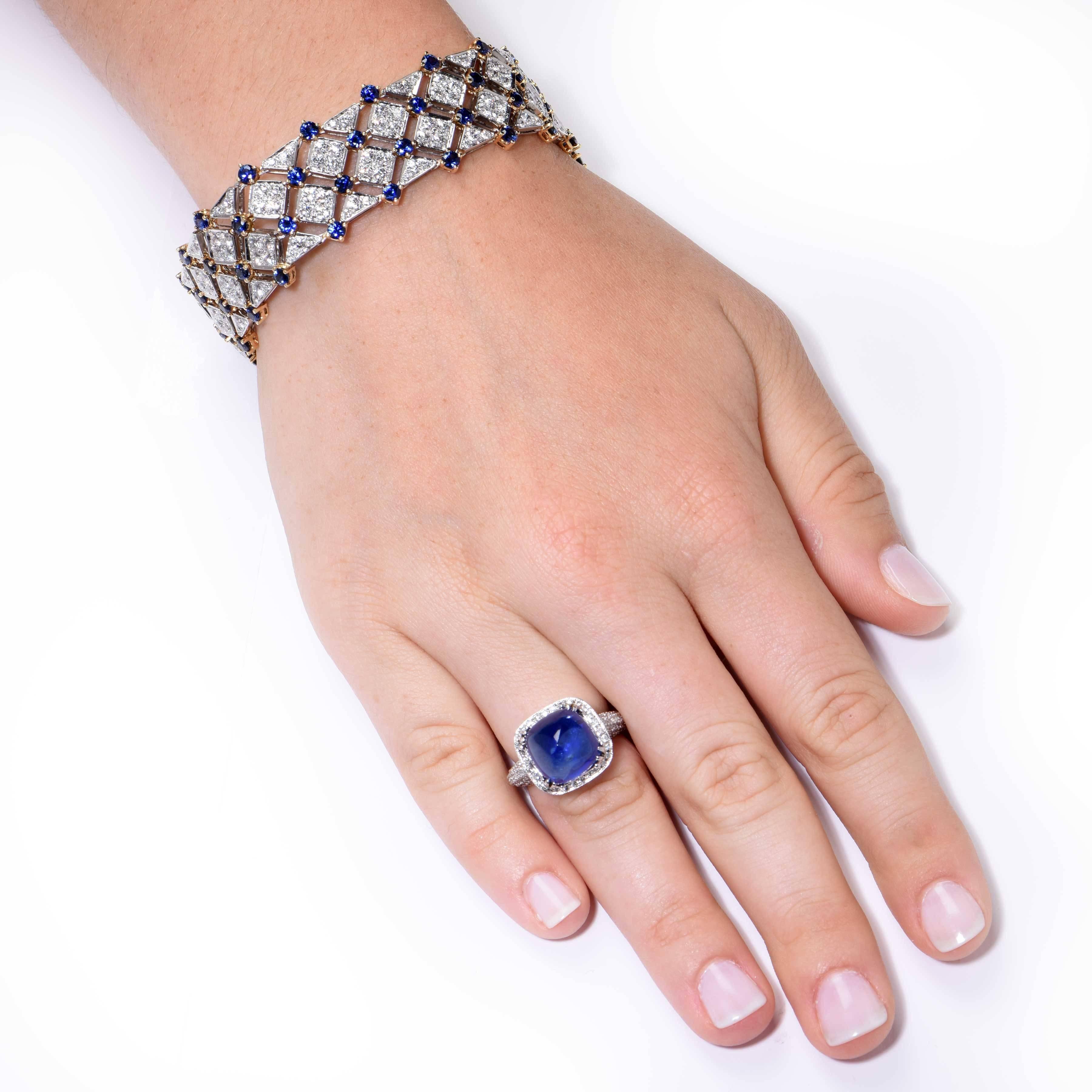 This stunning ring features a natural 10.48 Cts. Sugarloaf Sapphire adorned  by round diamonds weighing 1.72 Cts, set in 18 Kt white gold.

Size 6 1/4. Can be sized
Metal Type: 18 Kt White Gold (tested and/or stamped)
Metal Weight: 8.6 Grams