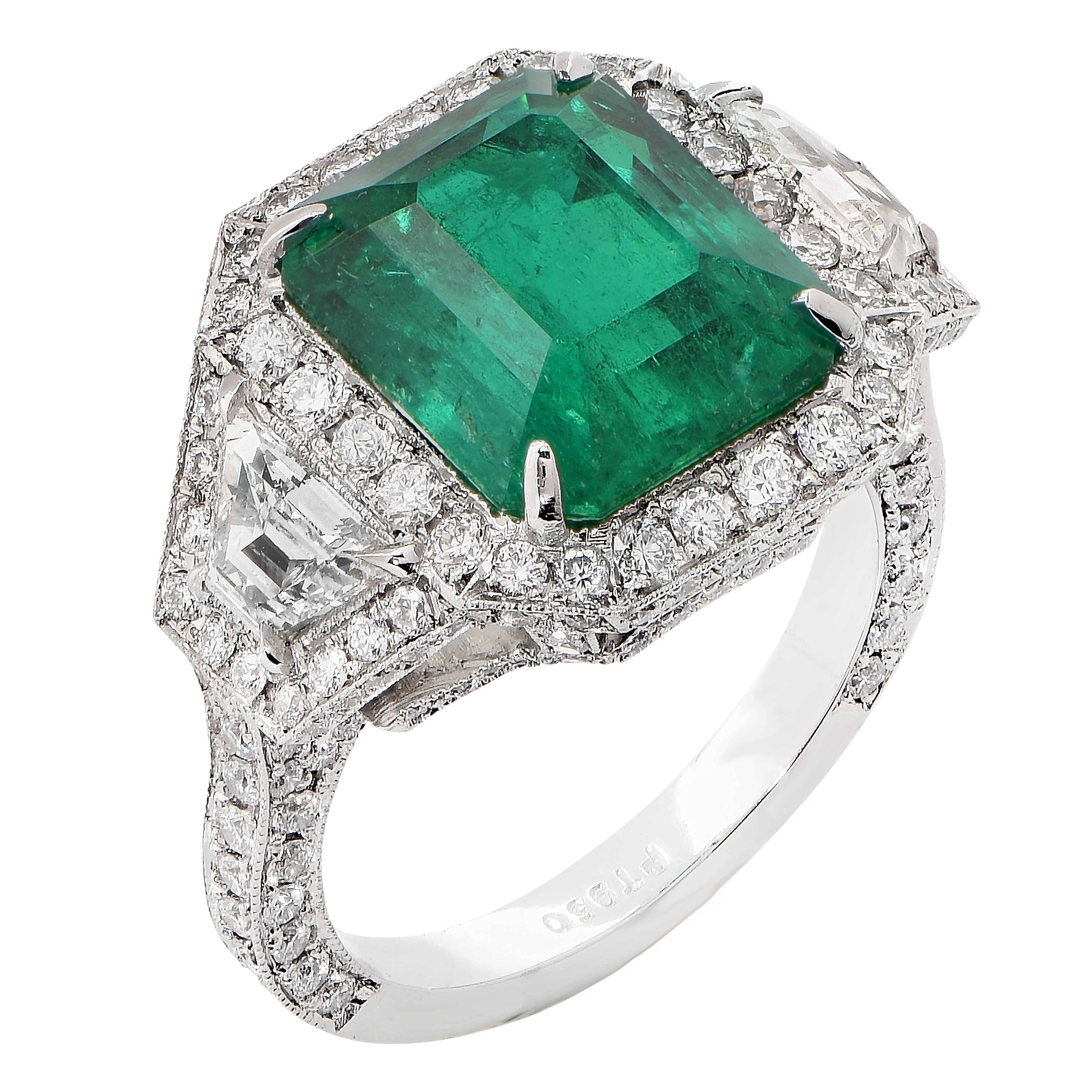 This ring features an exquisite 6.10 carat Colombian emerald. The emerald has not been oiled or treated in any way, as per an AGL certificate. The ring also contains 2 trapezoid diamonds weighing 0.71 carats and round diamonds weighing 1.38