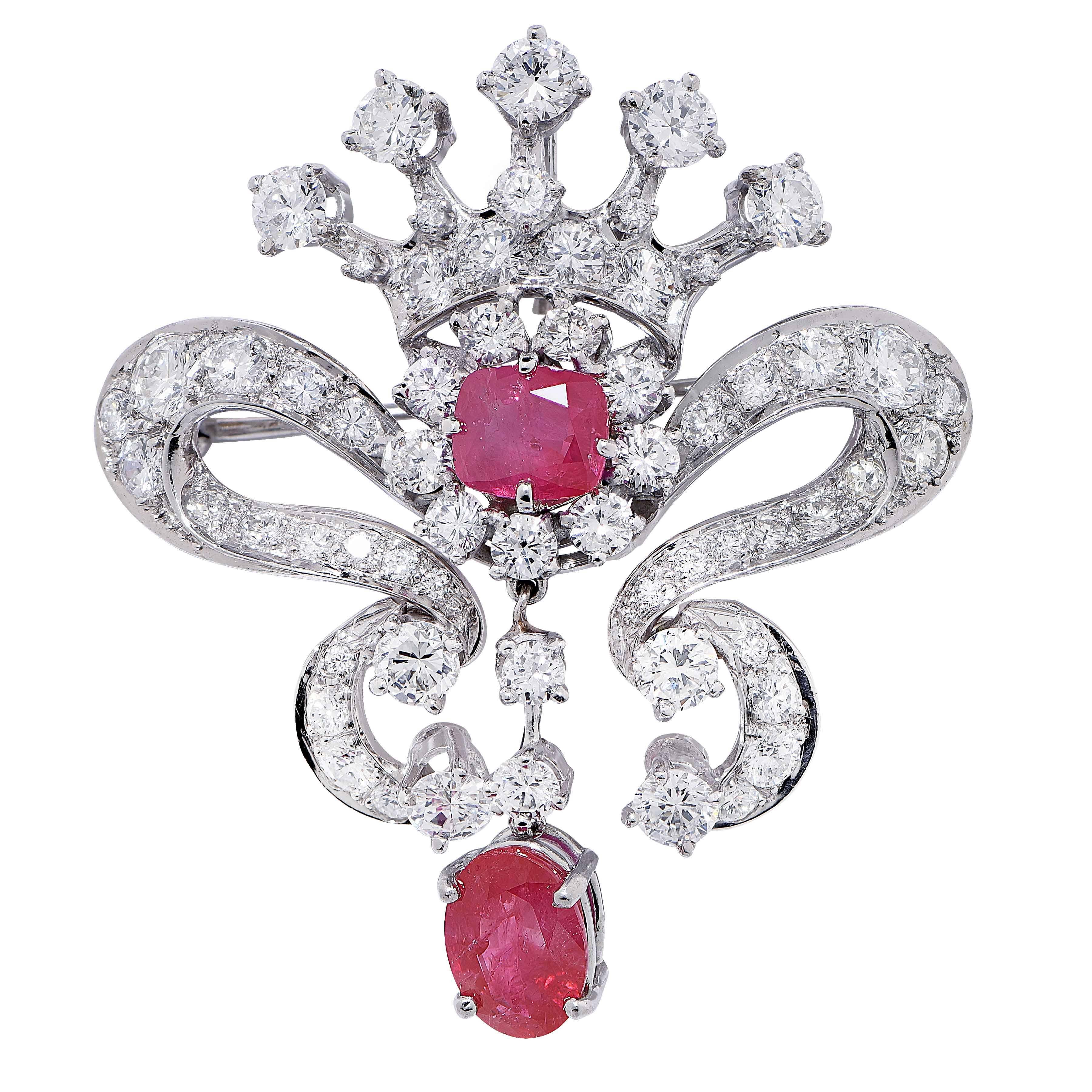 Mid Century Open Ribbon design brooch featuring  2 Burmese rubies, one oval and one cushion shaped, weighing approximately 3.70 Cts. in total, and 61 round cut diamonds weighing approximately 6.50 Cts. set in a platinum brooch.

Metal Type: Platinum