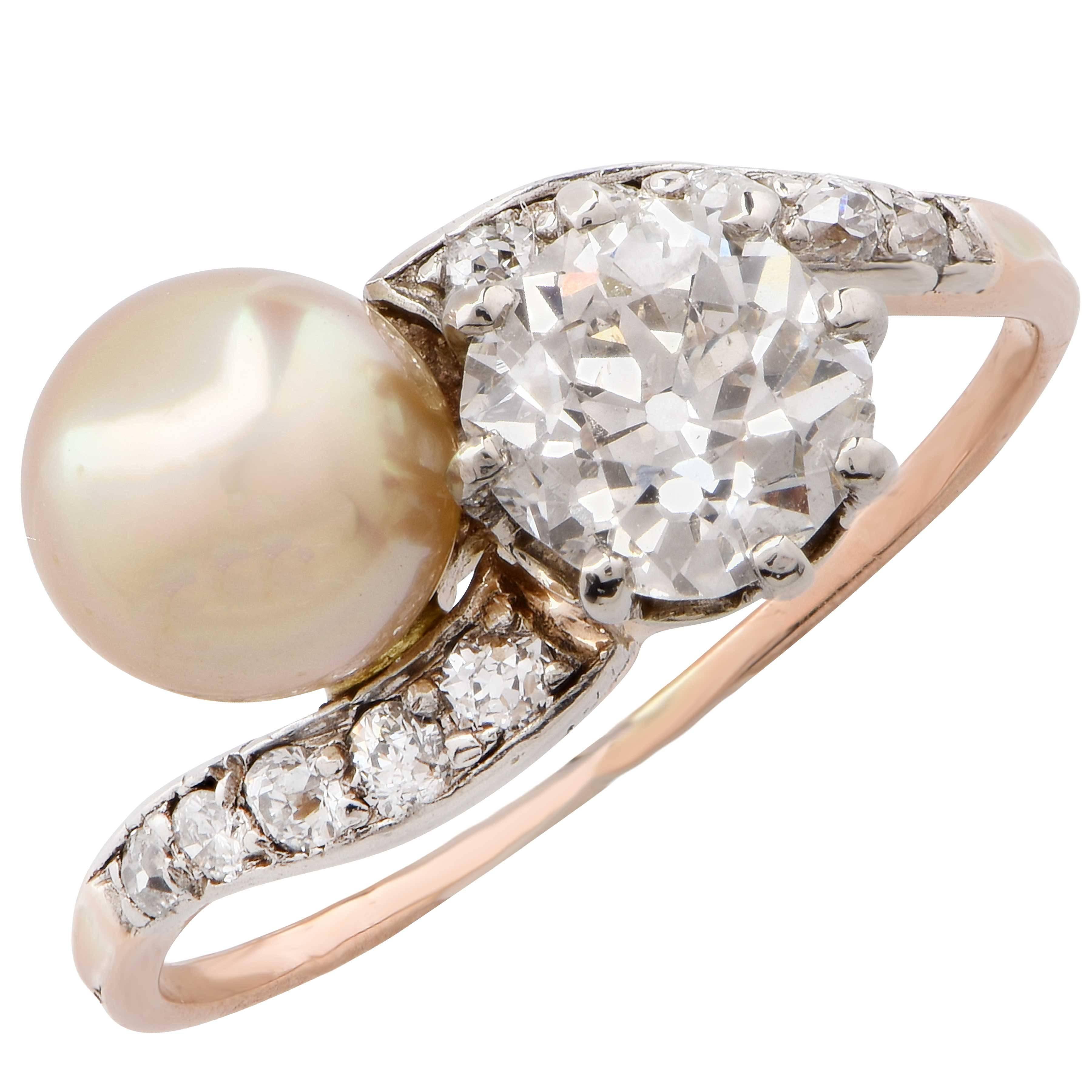 Pearl and diamond crossover ring.
Old Miner cut diamond weighing 1.00 carats. GIA certified: color I, Clarity SI2. 
Size 6 3/4. Can be sized.