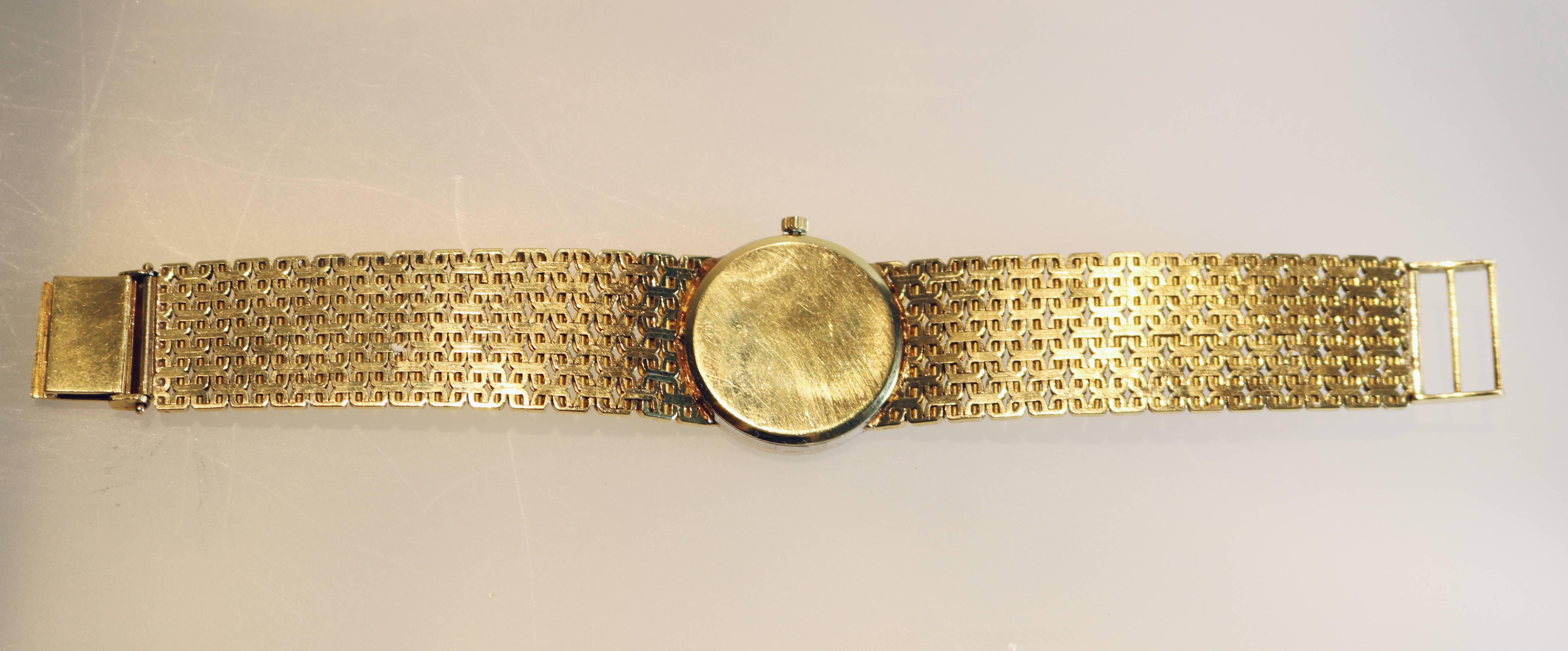 Ladies Ebel watch in 18K gold with a diamond bezel set with single cut diamonds. Italian gold Corletto bracelet measuring 5 3/4" in length.  The face of the watch is  25mm in diameter.  The dial has several very small hairline fractures. 
