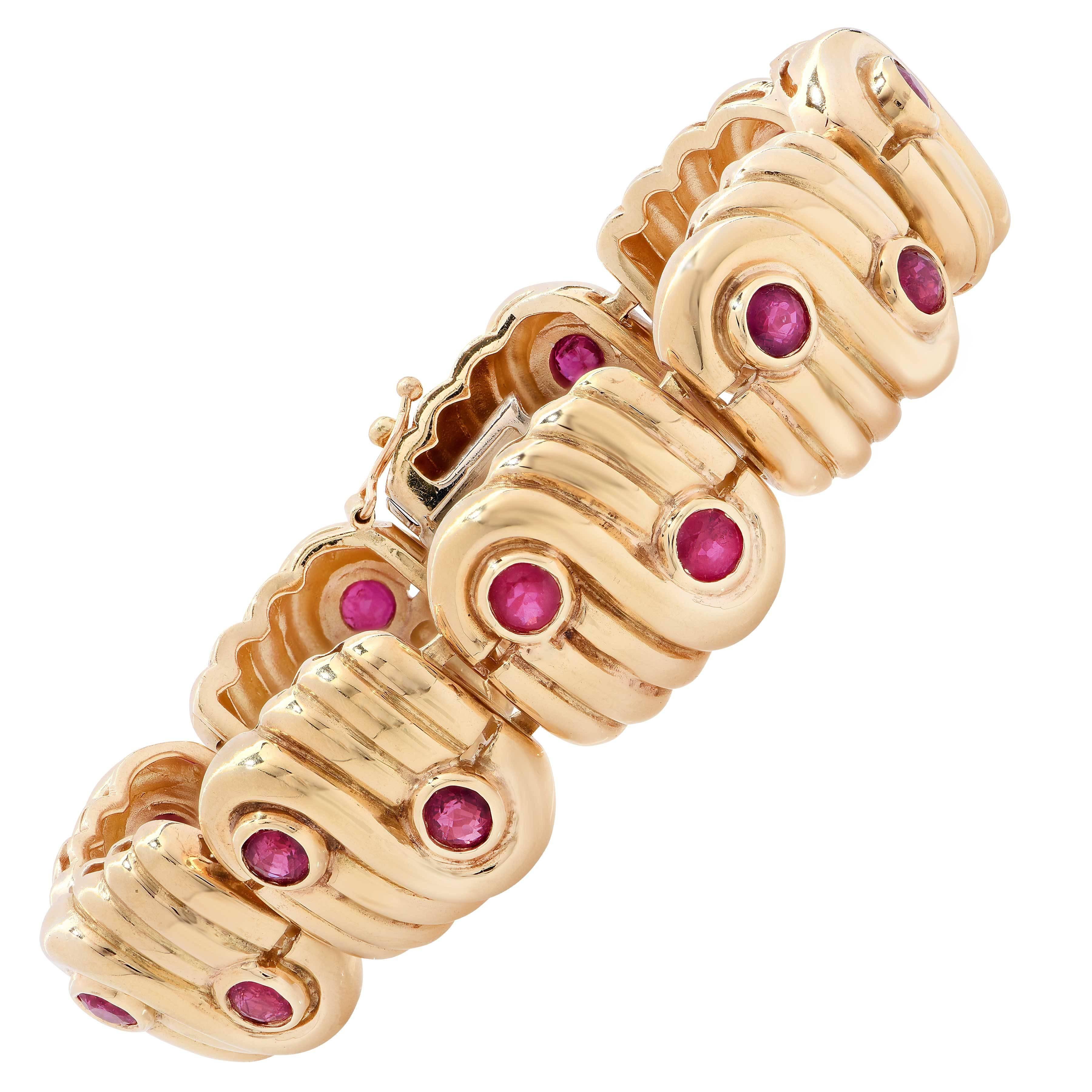 1980's Retro Design Bracelet featuring 18 bezel set rubies weighing approximately 5.40 carats. Each of the 9 high polished links has a swirling design set with 2 rubies.  
Total weight is 75 grams. 
Length of bracelet is 6 3/4 inches.

Metal Type: