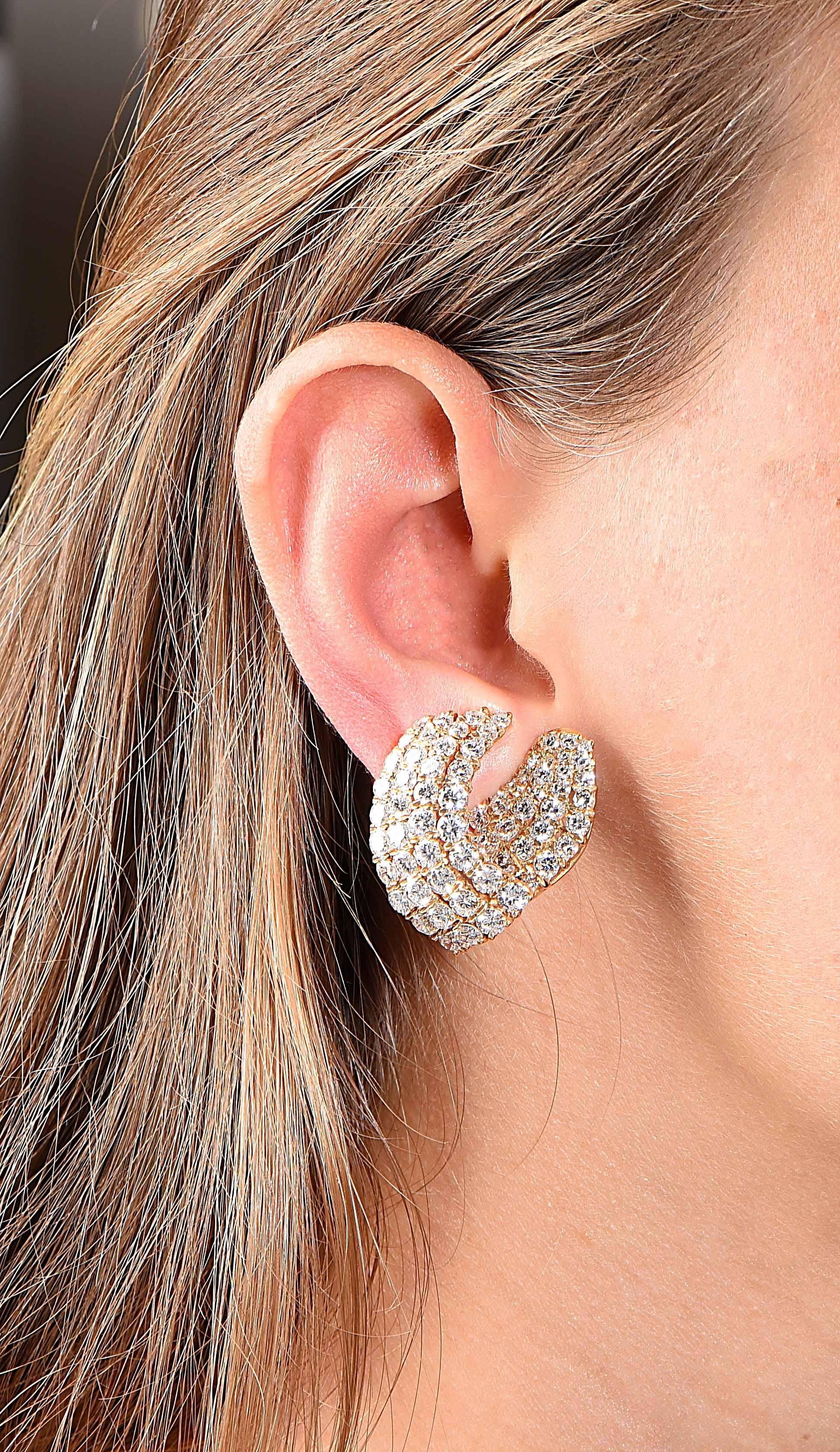 Lively diamond ear clips set with 182 round diamonds in graduated rows, weighing approximately 11 carats. The approximate color and clarity of the diamonds are G VS. Posts can be added at no charge.

Metal Type: 18 Karat Yellow Gold Tested and