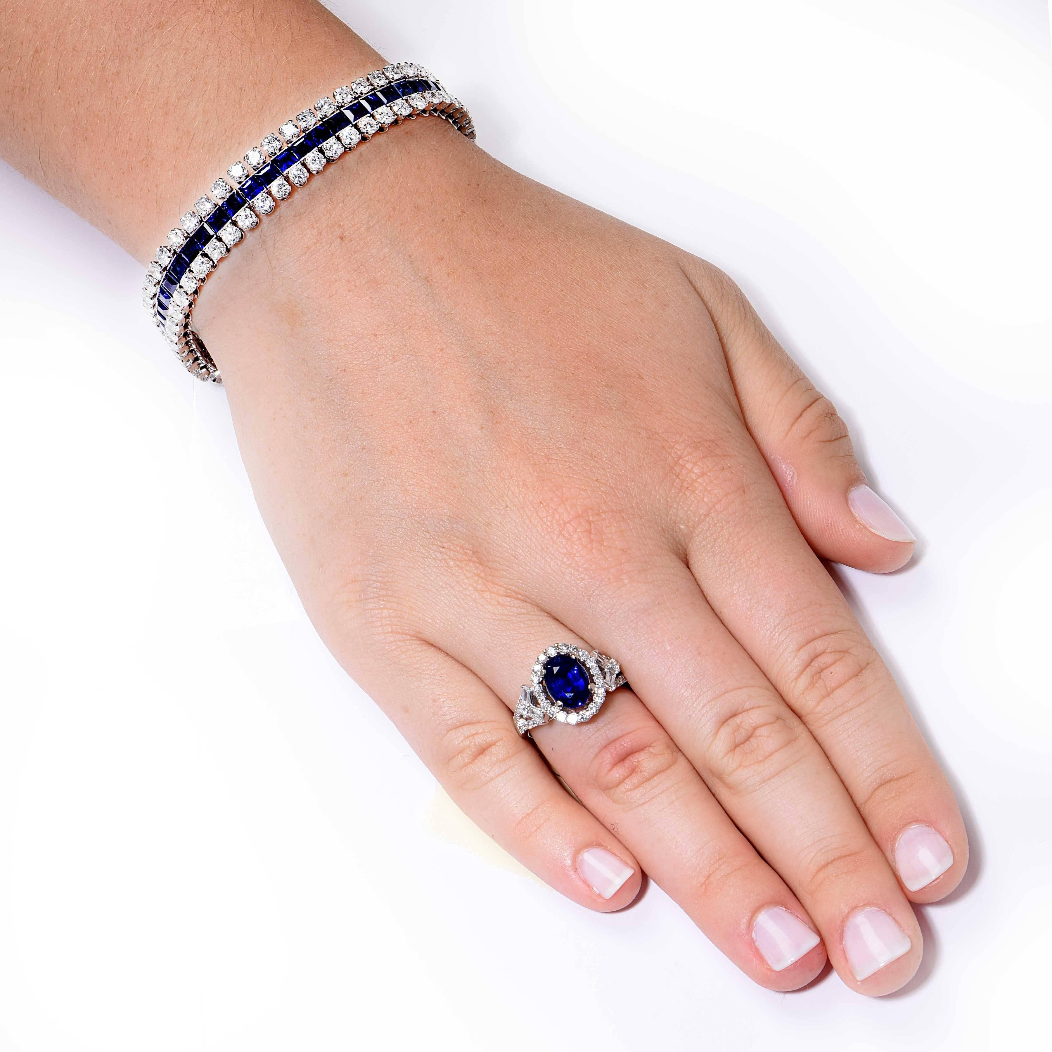 Very flexible sapphire and diamond bracelet. The bracelet is set in the center with calibre-cut deep blue sapphires. It is further set with 2 rows of round diamonds weighing approximately 9 carats. The diamonds are approximately G in color and VS in