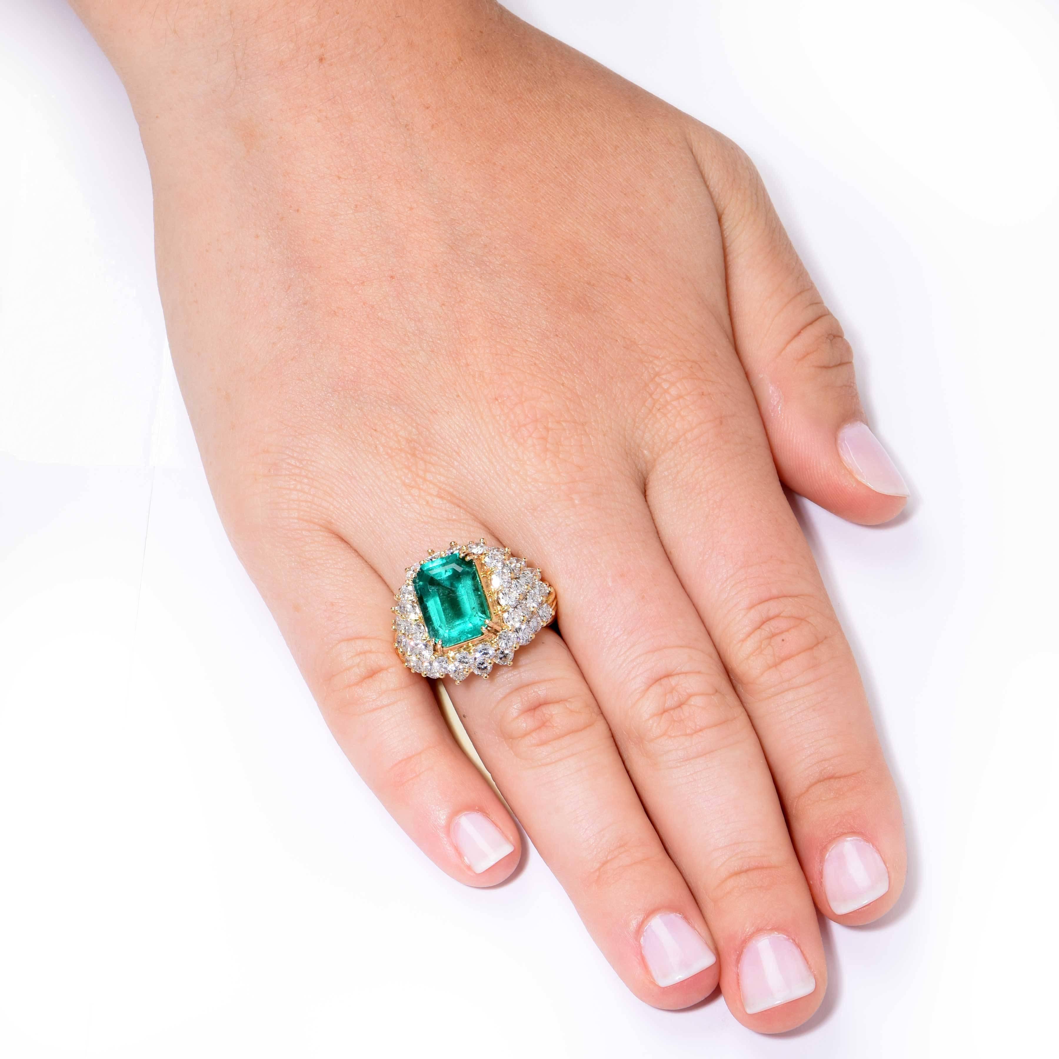 This beautiful natural Colombian Emerald and Diamond Ring features an emerald cut emerald weighing 6.20 carats, and round brilliant cut diamonds weighing 5.20 carats. The diamonds are approximately G/H in color and VS in clarity. 

Metal 18 KT