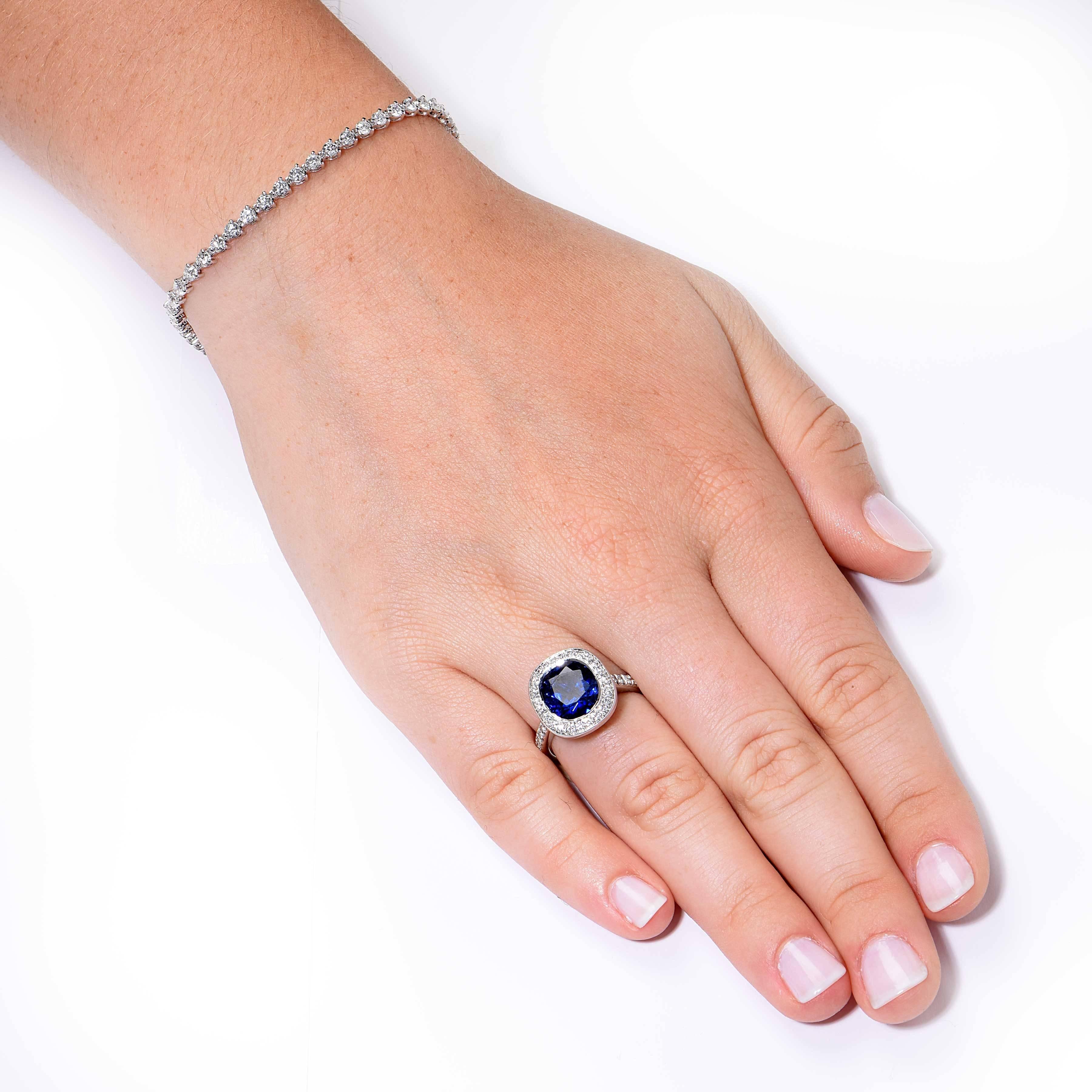 This gorgeous 5.04 Burma No Heat (AGL Cert) Sapphire is surrounded by round brilliant cut diamonds and set in a platinum mounting. 

Ring Size: 6 1/4 (can be sized)
Metal: Platinum (Stamped and/or Tested)
Metal Weight: 12 Grams

