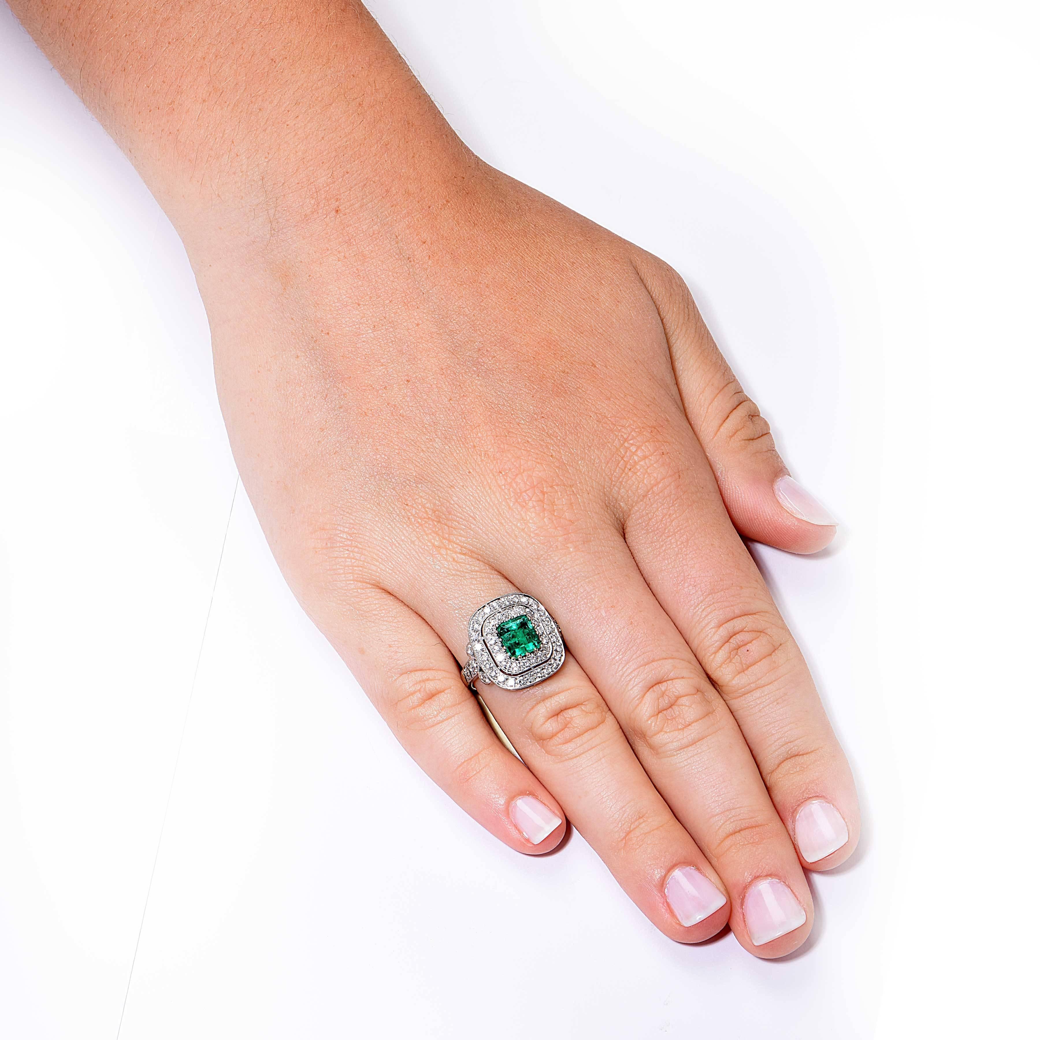 This beautiful ring features a natural emerald with an approximate weight of 1.5 carats surrounded by 58 round brilliant cut diamonds with an approximate weight of 1.5 carats. 

Ring size: 6 3/4 (can be sized)
Metal Type: 18 Kt White Gold (stamped